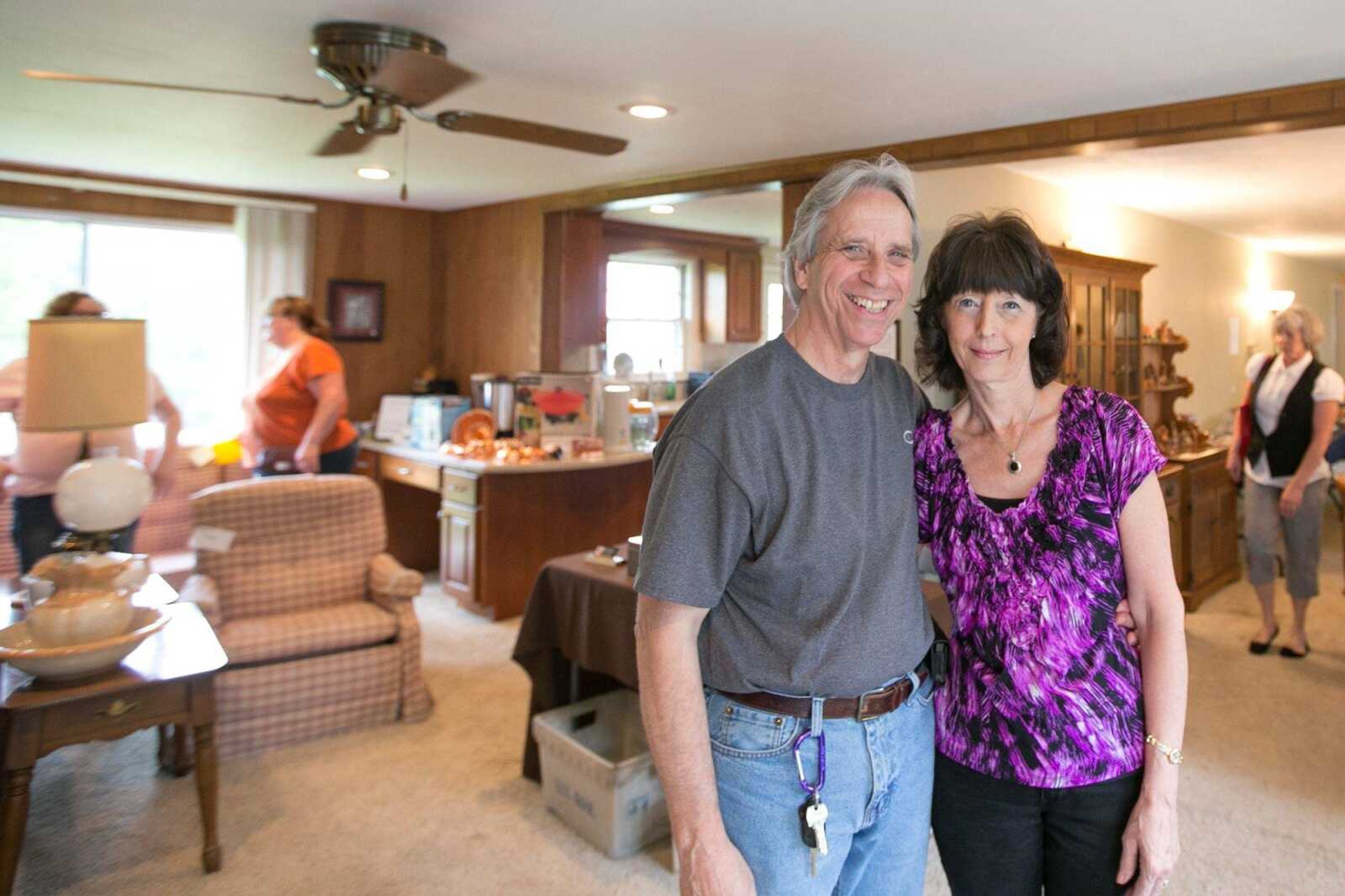 Tracy and Debbie Childers take a break from helping customers to pose for a photo at an estate sale they hosted May 16 in Cape Girardeau. (Glenn Landberg)