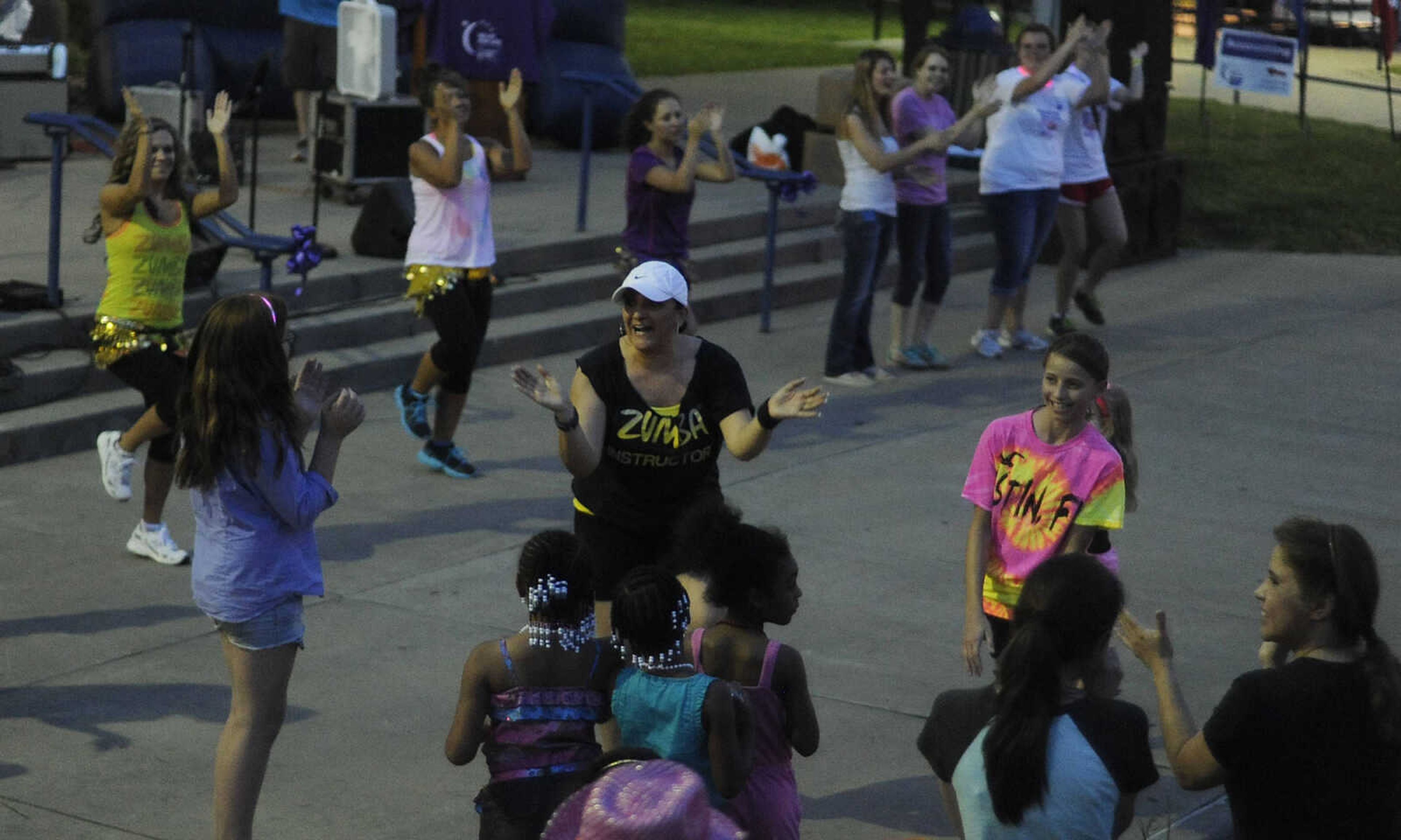 Marissa Higuera leads a Zumba class during the Relay for Life of Cape Girardeau County, Friday, June 14, at Arena Park in Cape Girardeau. This is the 15th year for the event, which serves to raise awareness about cancer while also serving as a fundraiser for the American Cancer Society. Participants form teams which raise money before and during the event.