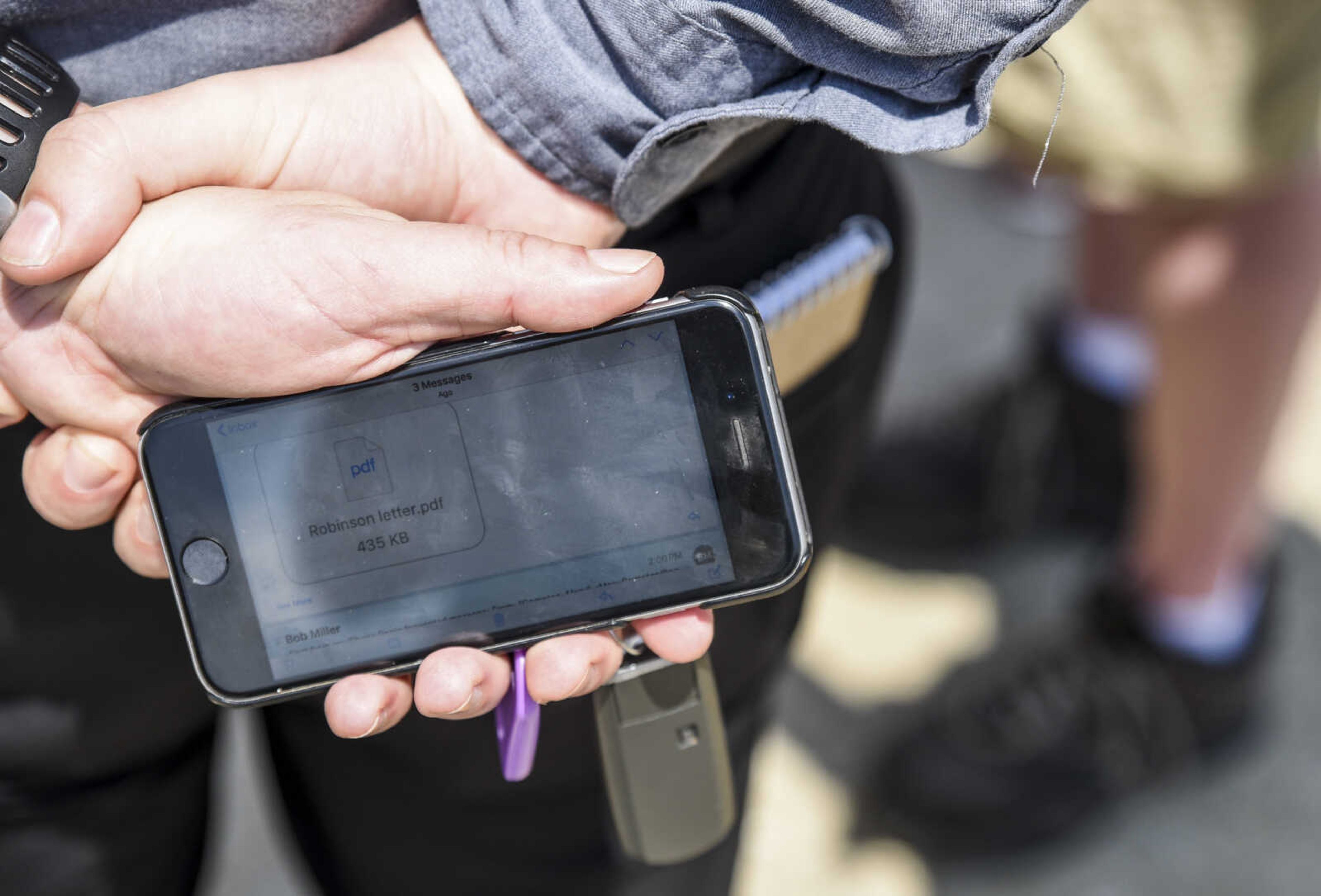 Bob Miller holds his phone with the PDF letter of the Supreme Court's decision to release David Robinson from the Jefferson City Correctional Center Monday, May 14, 2018 in Jefferson City.