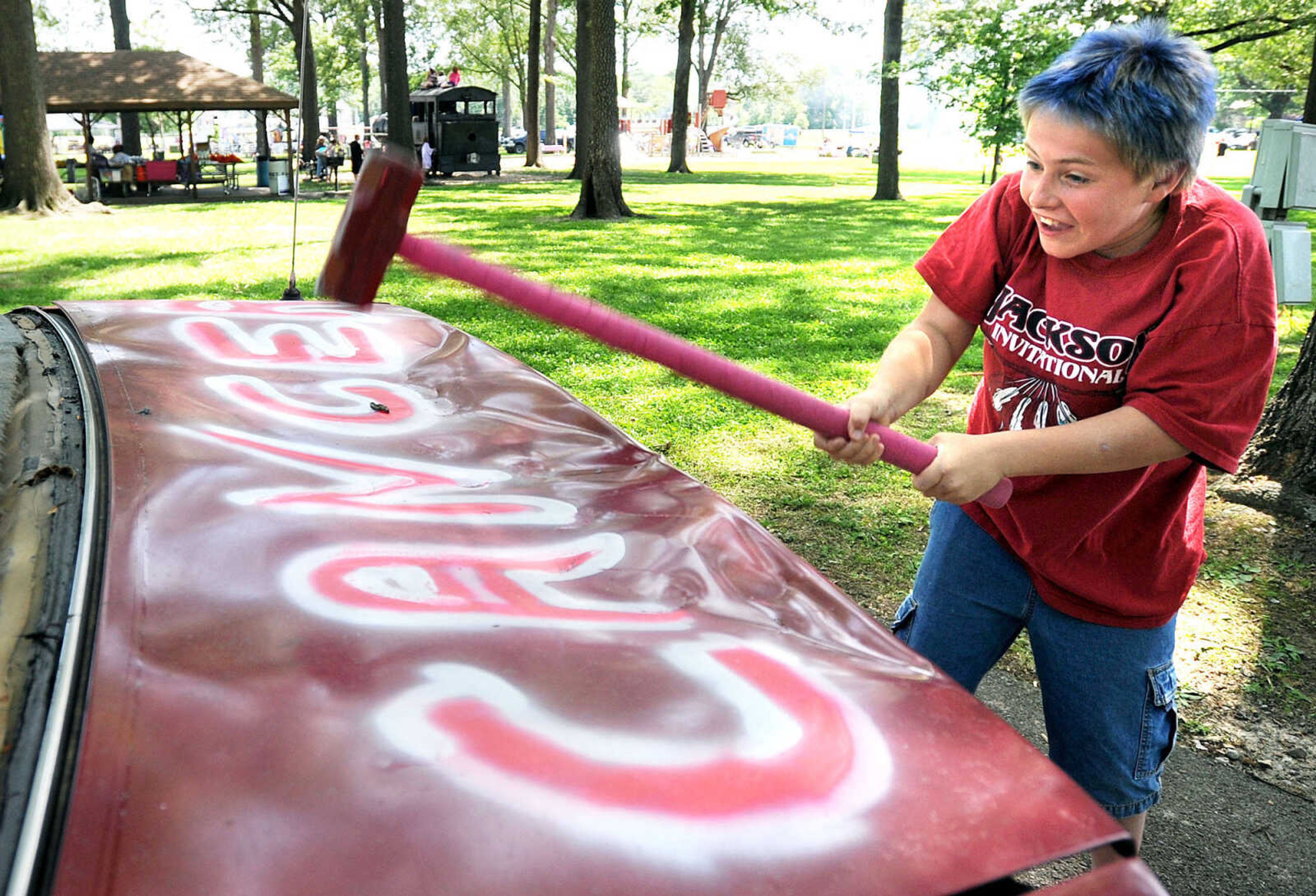 LAURA SIMON ~ lsimon@semissourian.com

Garret Vandeven, 11, smashes the trunk of a car, Saturday, June 14, 2014, during the Relay for Life of Cape Girardeau County fundraiser at Arena Park. People got three chances for a dollar to "help beat cancer"  at the "Got Hope" tent.