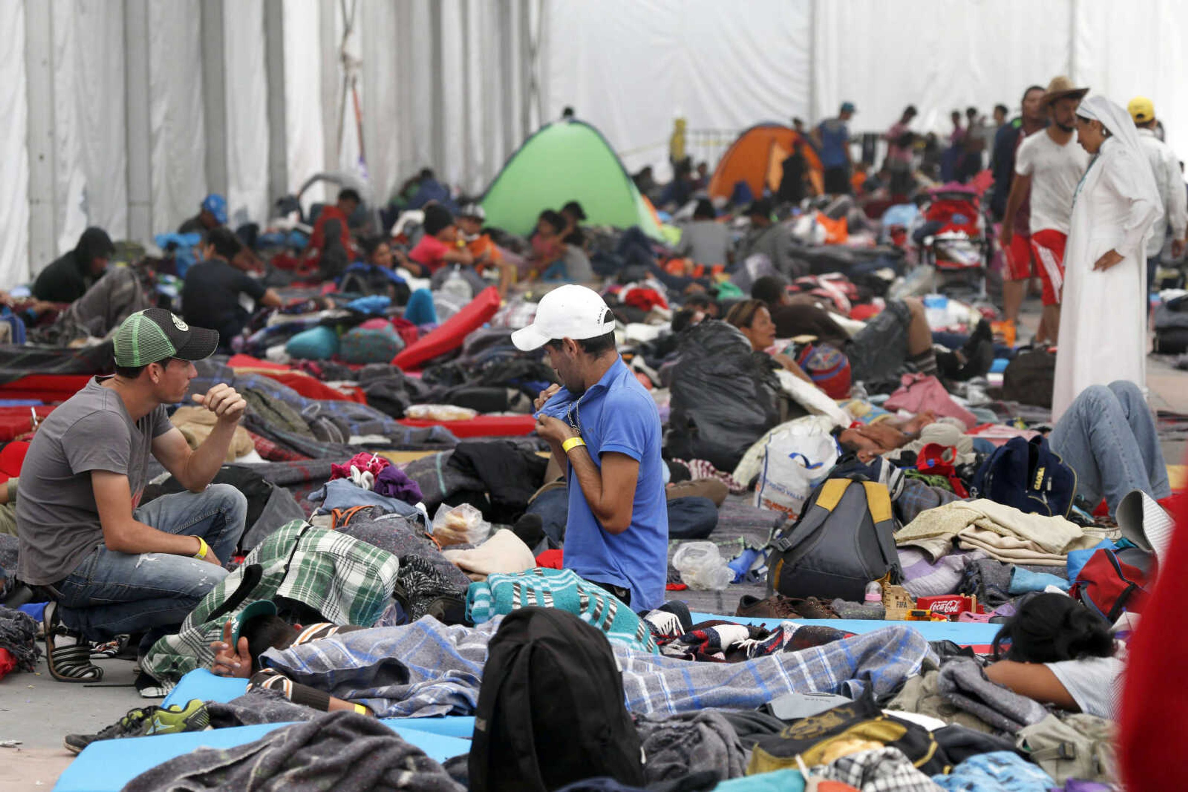 Central American migrants settle in a shelter Tuesday at the Jesus Martinez stadium in Mexico City.