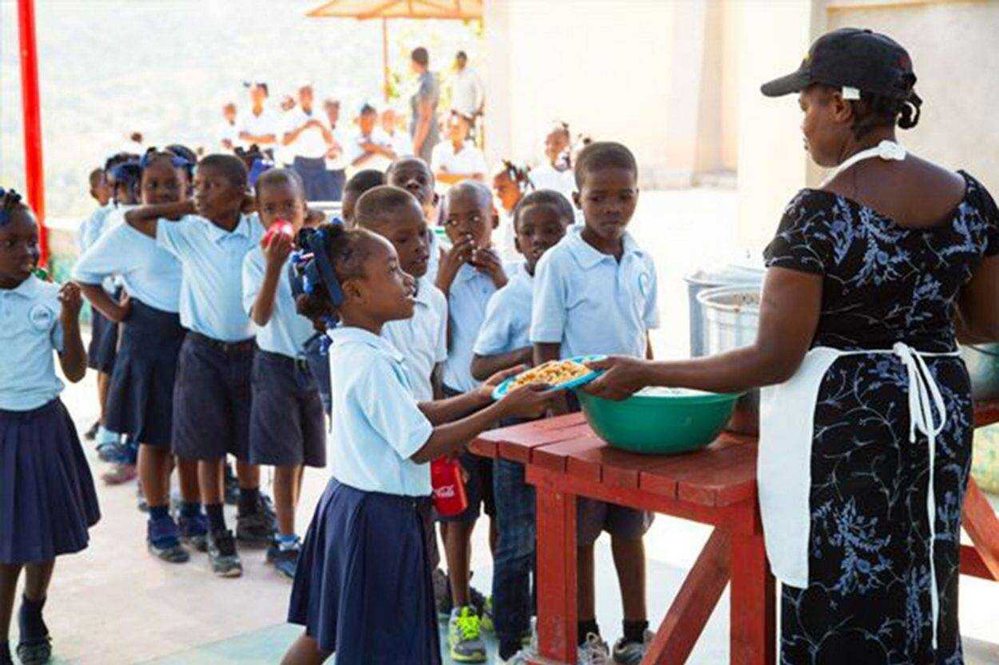 Children in the Respire Haiti Christian School line up to receive a meal.