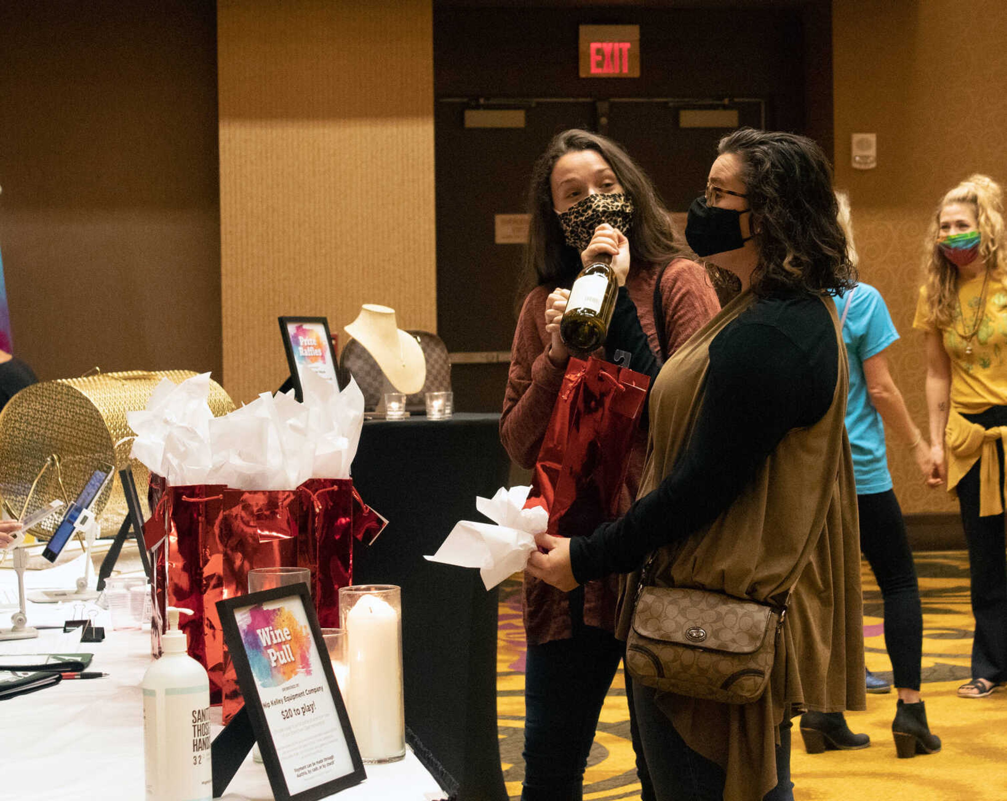 Brittney Swicionis (left) and her sister Rachel Swicionis excitedly open their gift from the Wine Pull at Old Town Cape's Revivify fundraiser on Thursday, Oct. 22, 2020, at Century Casino in Cape Girardeau.