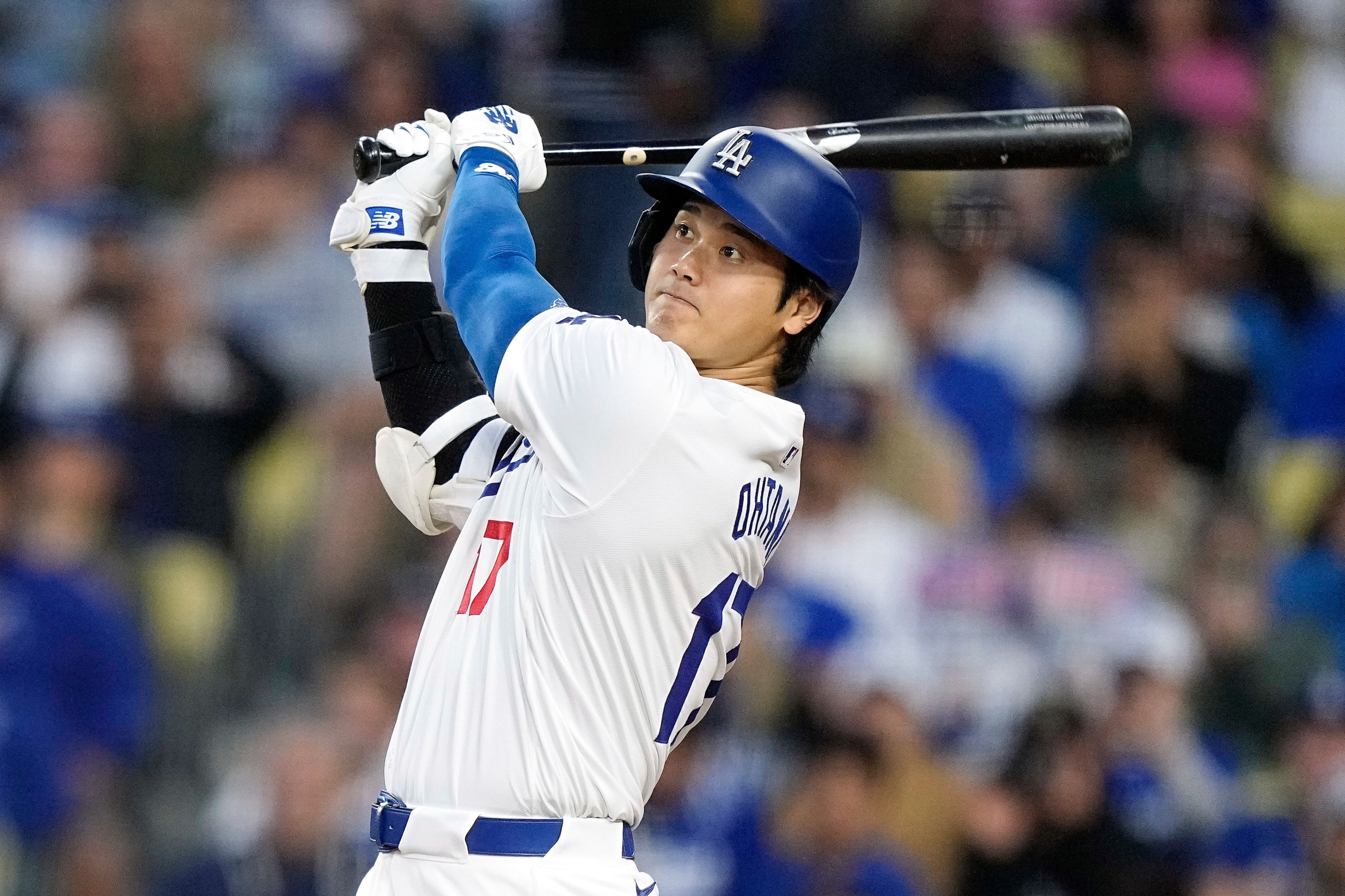 Los Angeles Dodgers designated hitter Shohei Ohtani hits a two-run home run during the third inning of a baseball game against the Cincinnati Reds Friday, May 17, 2024, in Los Angeles. (AP Photo/Mark J. Terrill)