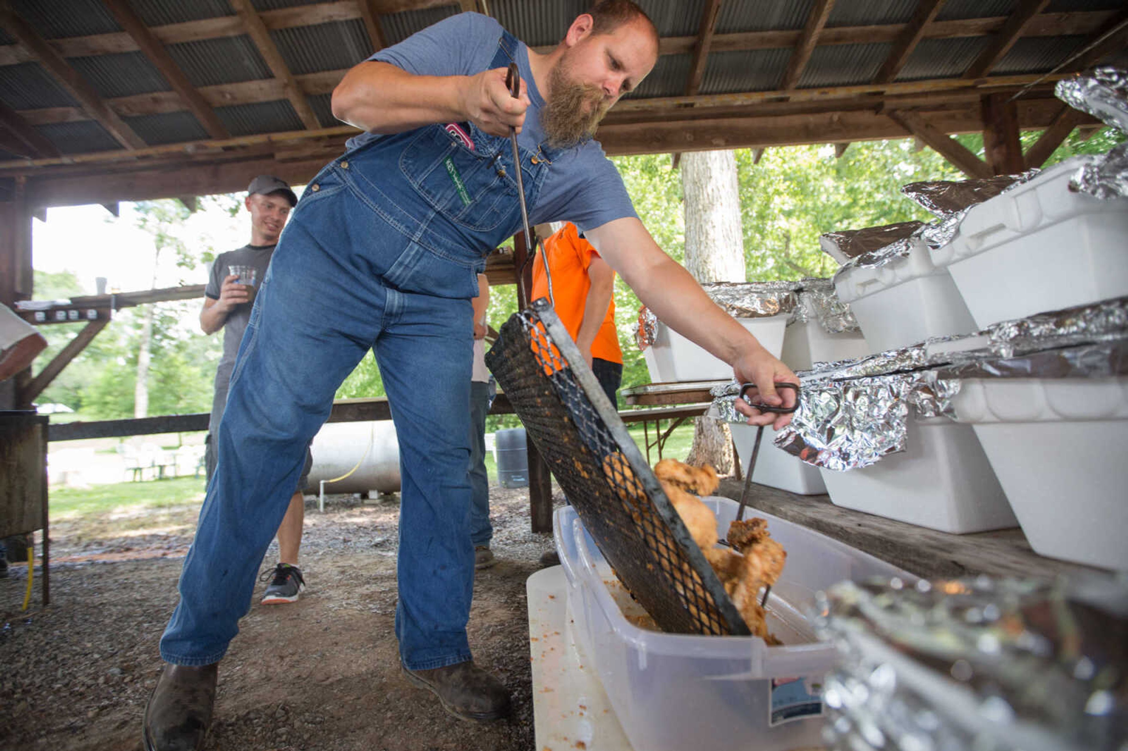 GLENN LANDBERG ~ glandberg@semissourian.com


Ashton James dumps a tray of fried chicken while preparing for the annual parish picnic on Saturday, July 30, 2016 at St. John's Catholic Church in Leopold, Mo.