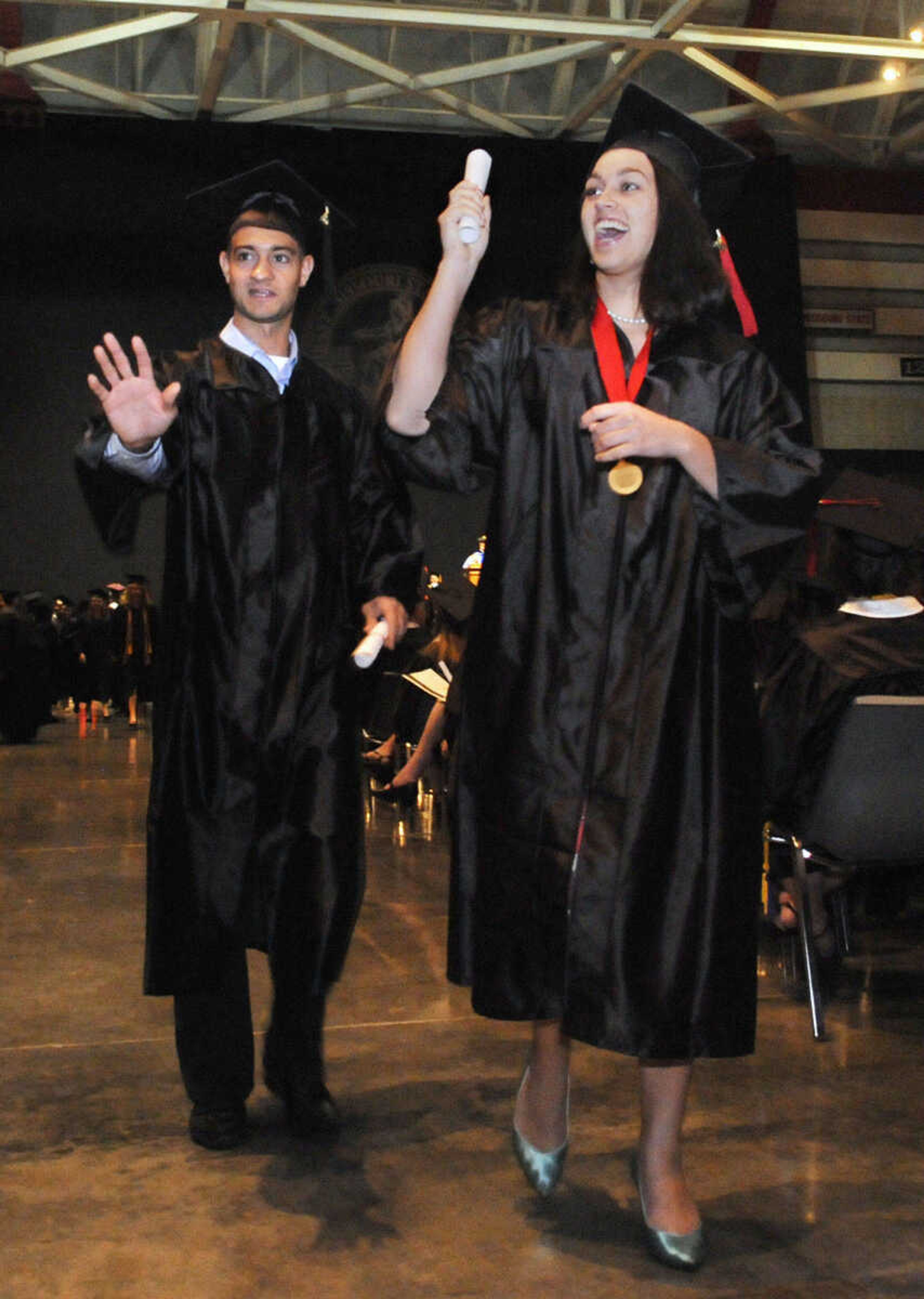 KRISTIN EBERTS ~ keberts@semissourian.com

Students wave at family and friends after receiving their diplomas during Southeast Missouri State University's 2010 Commencement at the Show Me Center on Saturday, May 15.