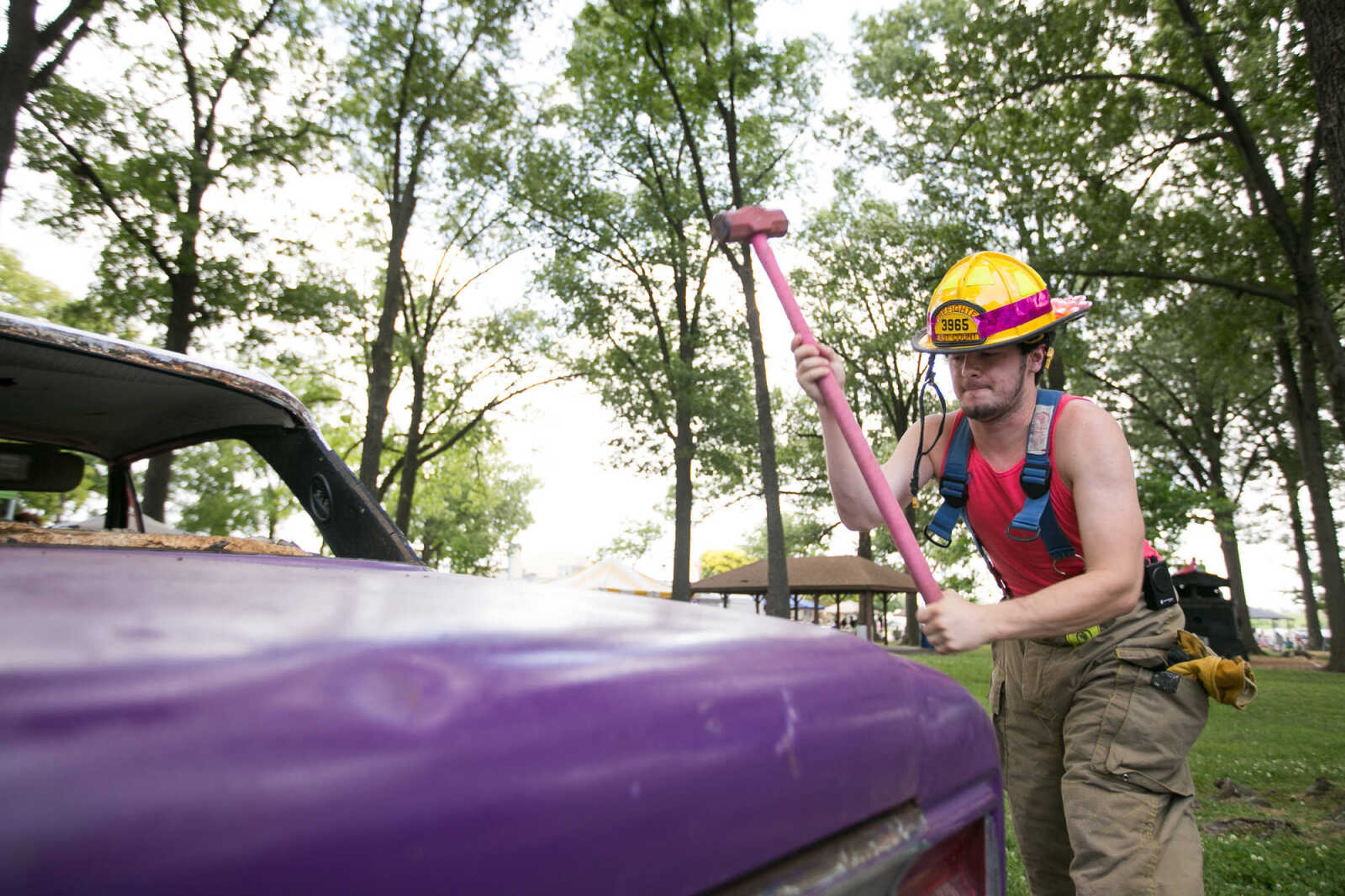 GLENN LANDBERG ~ glandberg@semissourian.com

Dylan Kavanaugh, a firefighter with the East County Fire Department, uses a sledgehammer to make his dent in a car during the Relay for Life of Cape Girardeau County fundraiser at Arena Park, Saturday, June 13, 2015. Proceeds from the car wrecking event are donated to the American Cancer Society.