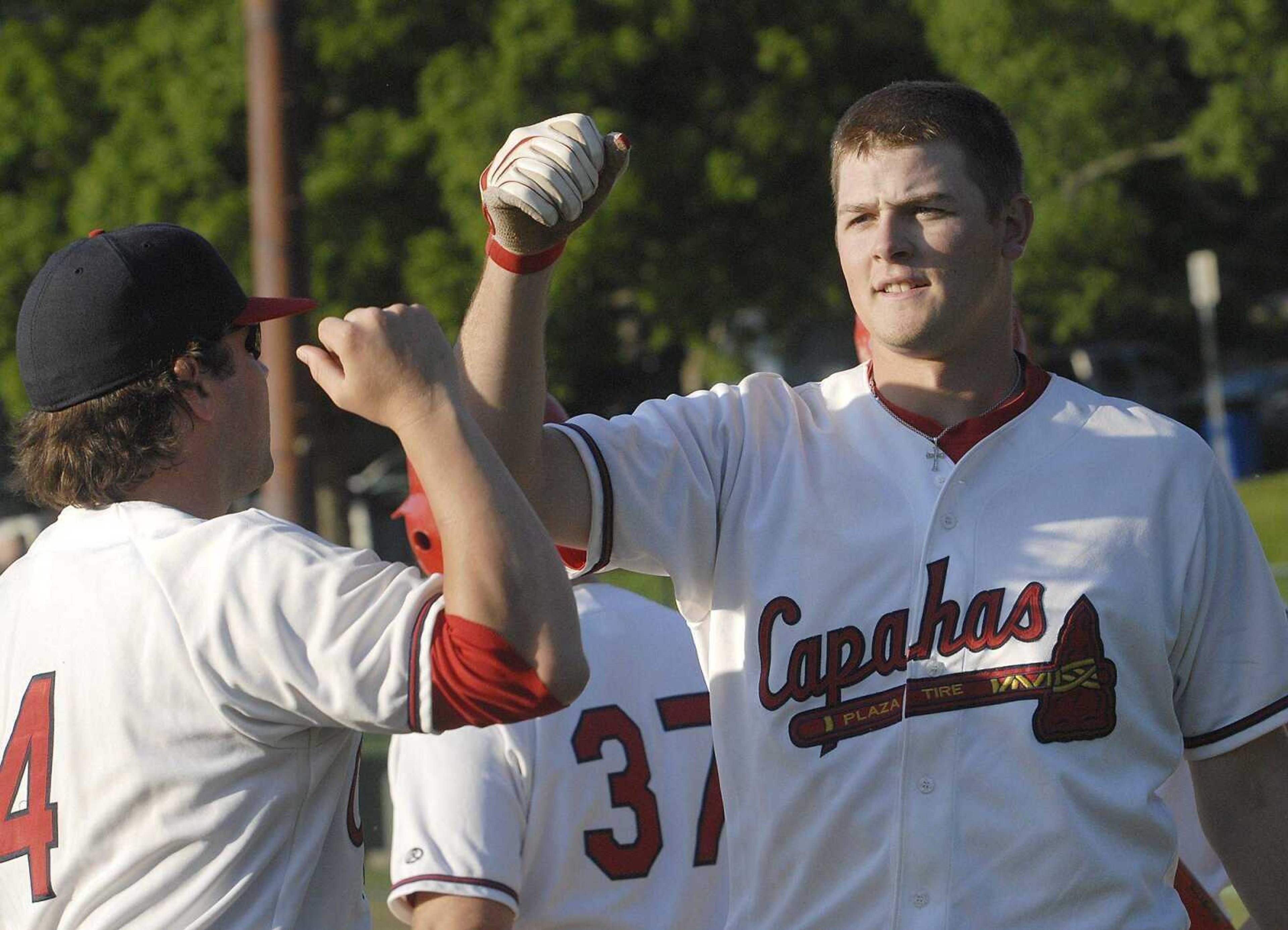 Matt Wagner is congratulated after his three-run homer for the Plaza Tire Capahas in the sixth inning against the Riverdogs Sunday at Capaha Field. (Fred Lynch)