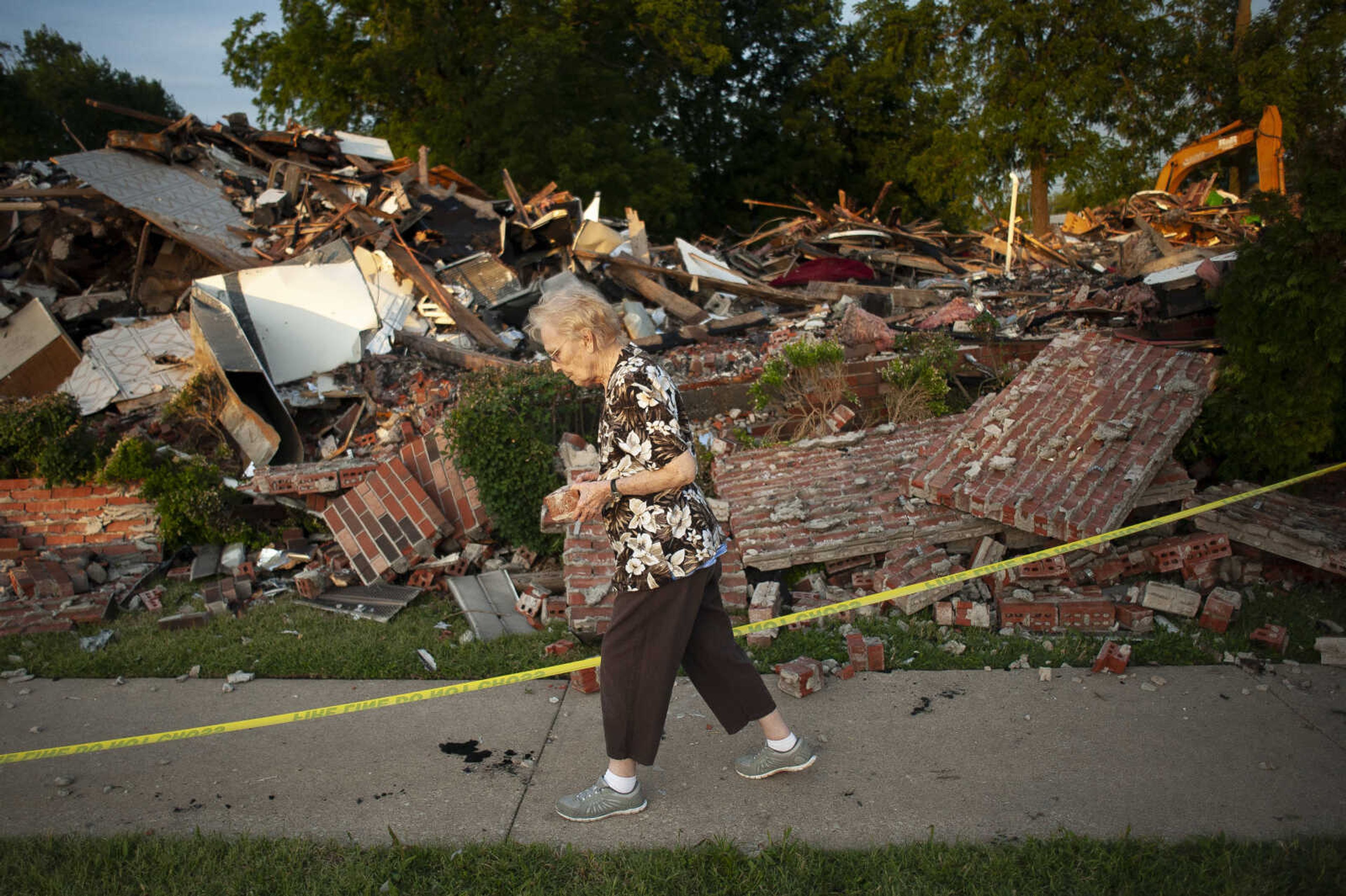 Arleen Tipsword, who at age 90 believes herself to be the oldest member of Cornerstone Wesleyan Church, takes a brick as a souvenir from the remains of the church Saturday, June 22, 2019, at 210 E Outer Road in Scott City, Missouri. "It's heartbreaking," Tipsword said of the building that was destroyed in a fire during Friday afternoon's storm. "I met my husband here in this church." She believes it was 1978 when she first attended the church where she would marry her husband in 1985. "I mean this is most wonderful church family that we can depend on," she said.