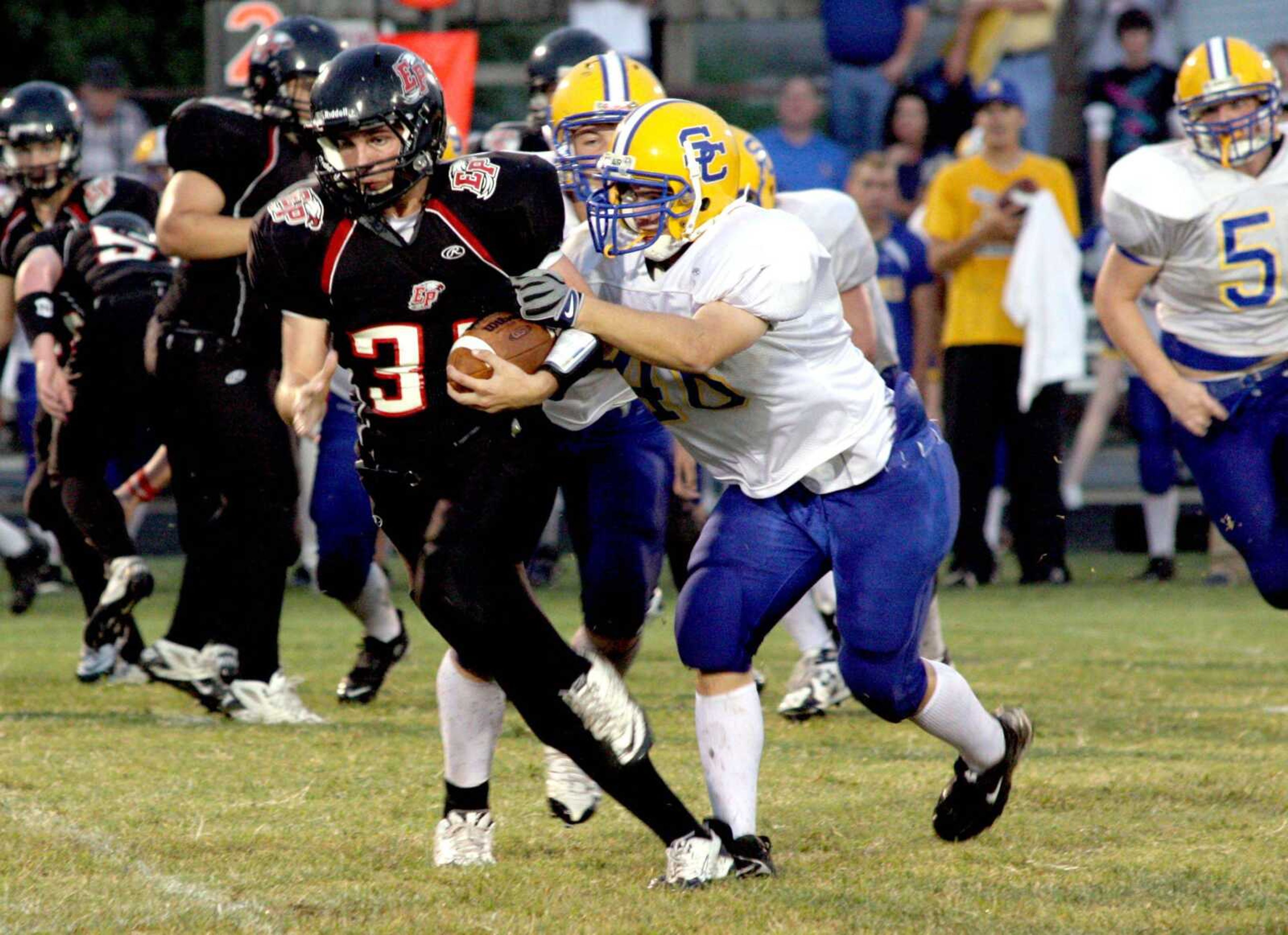 Scott City's Heath Pobst tries to tackle East Prairie running back Zach Shipman during Friday's game.