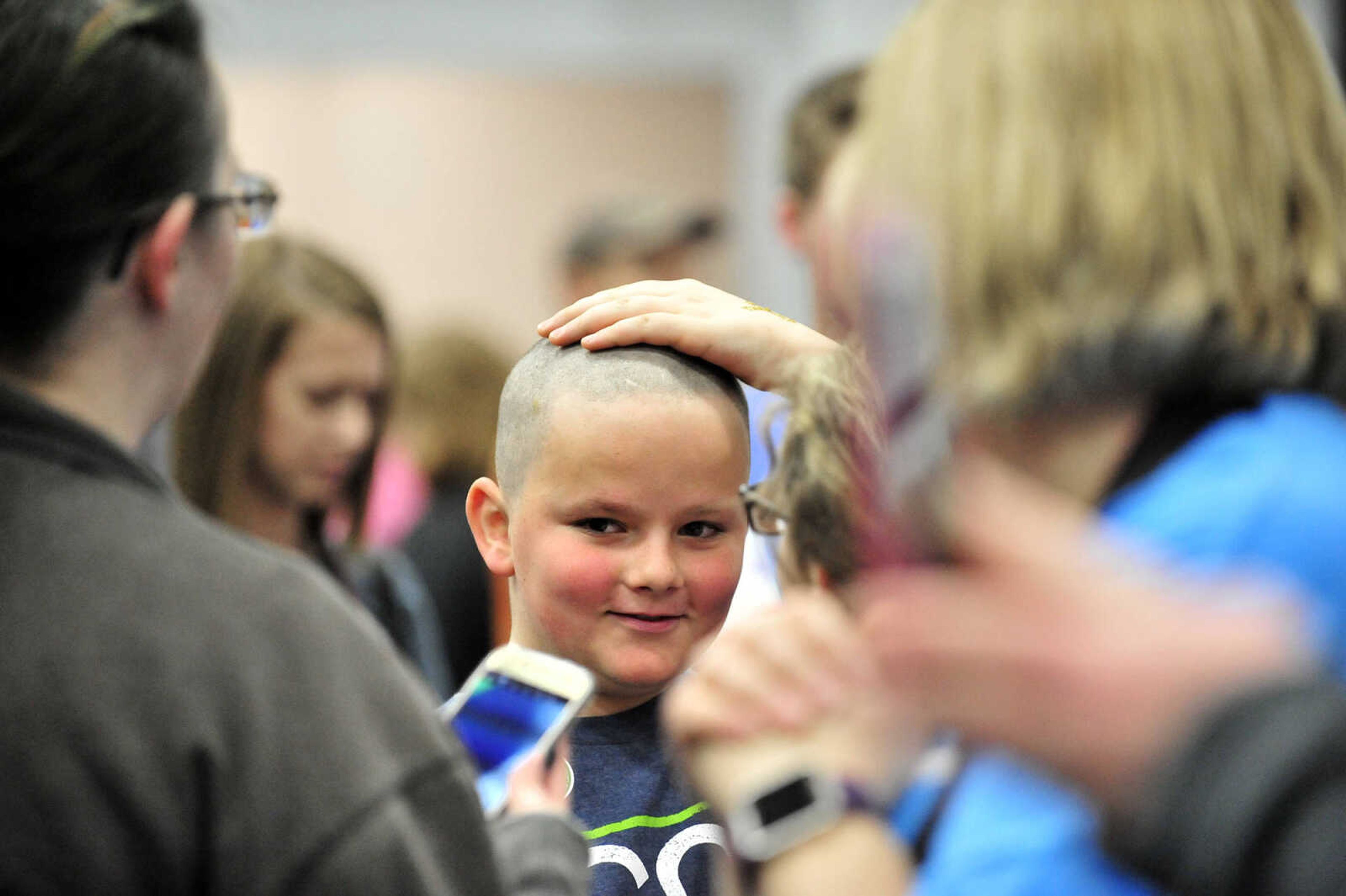 Matthew Brees, 10, feels his freshly shaved head on Saturday, March 4, 2017, during the St. Baldrick's Foundation fundraiser at Old Orchard CrossFit in Jackson.