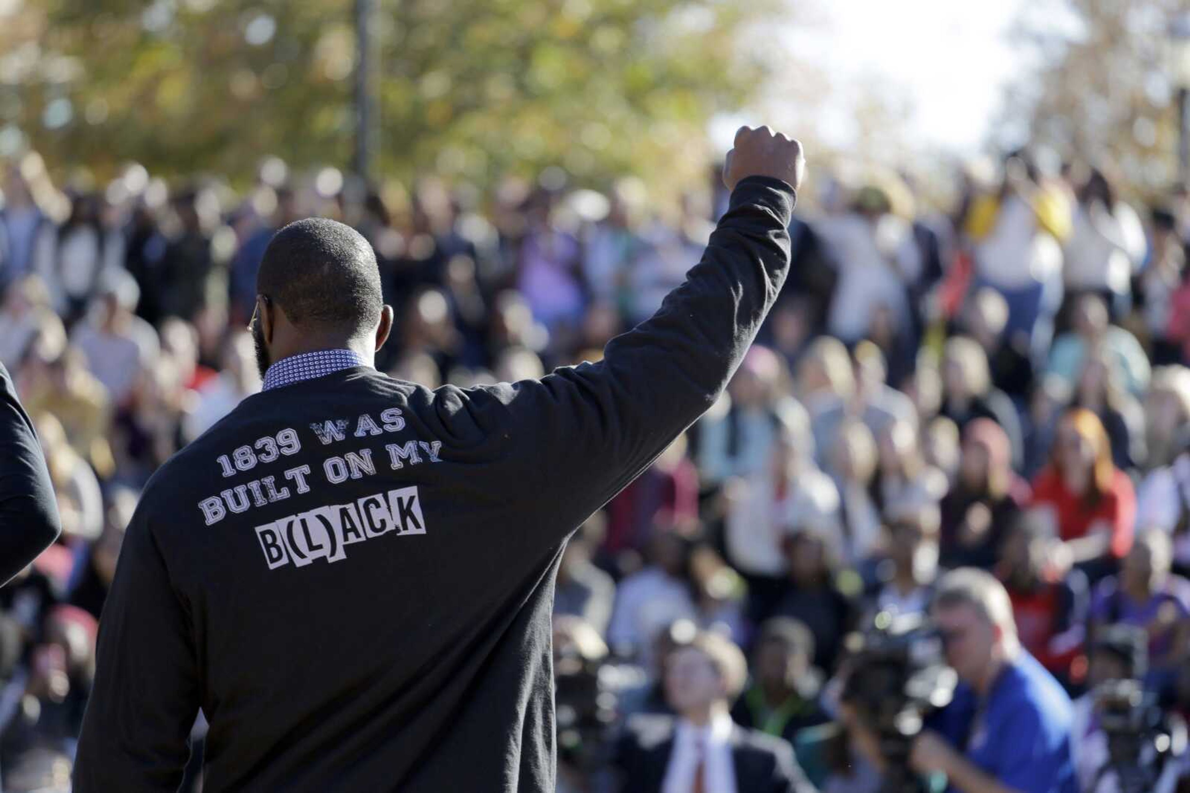 A member of the black student protest group Concerned Student 1950 gestures Nov. 9 while addressing a crowd following the announcement University of Missouri System president Tim Wolfe would resign. The roots of the protest began decades ago, when the University of Missouri, founded in 1839, enrolled its first black student in 1950. (Jeff Roberson ~ Associated Press)