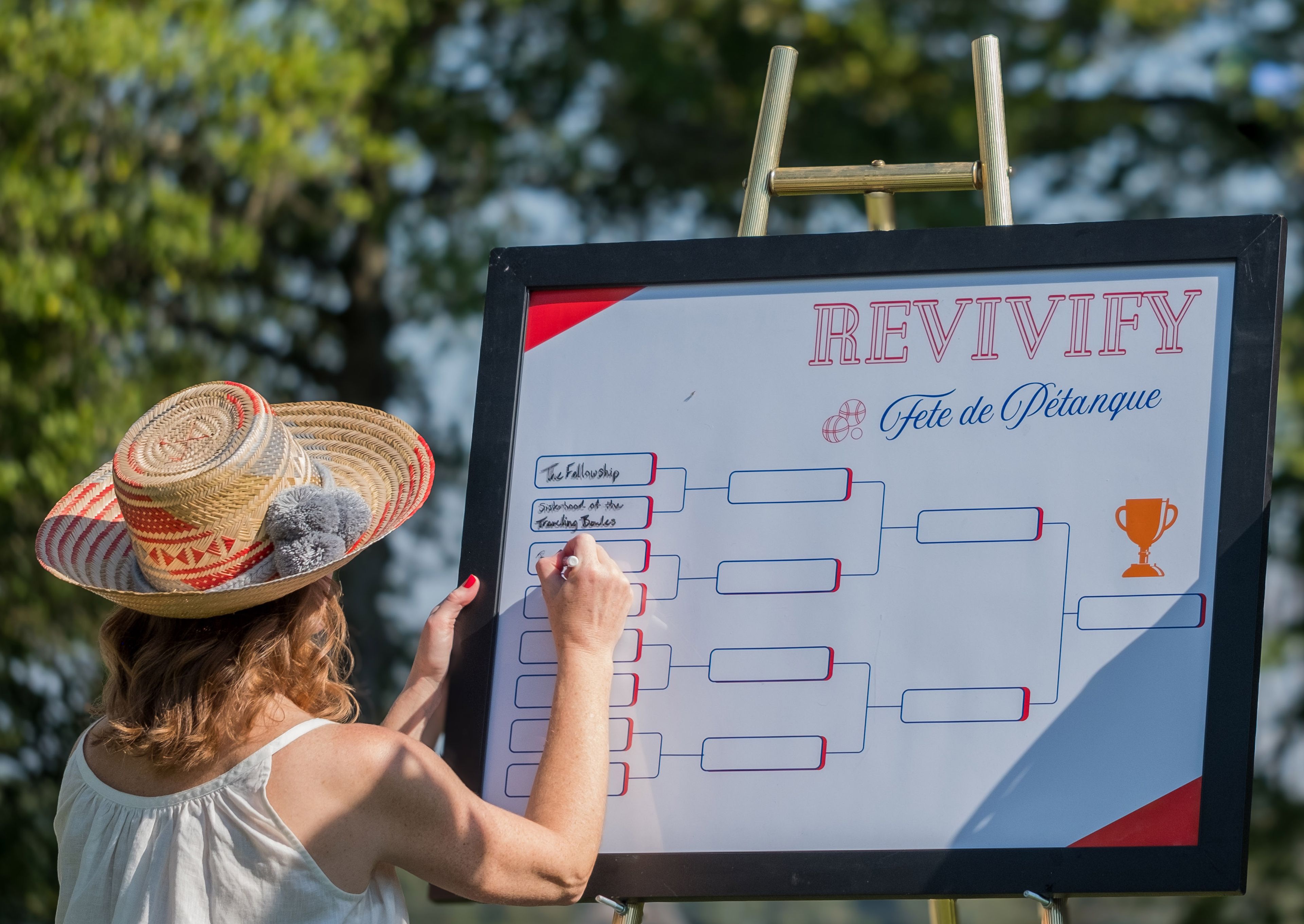 Event coordinators prepare the Pétanque court, setting the stage for friendly competition.
