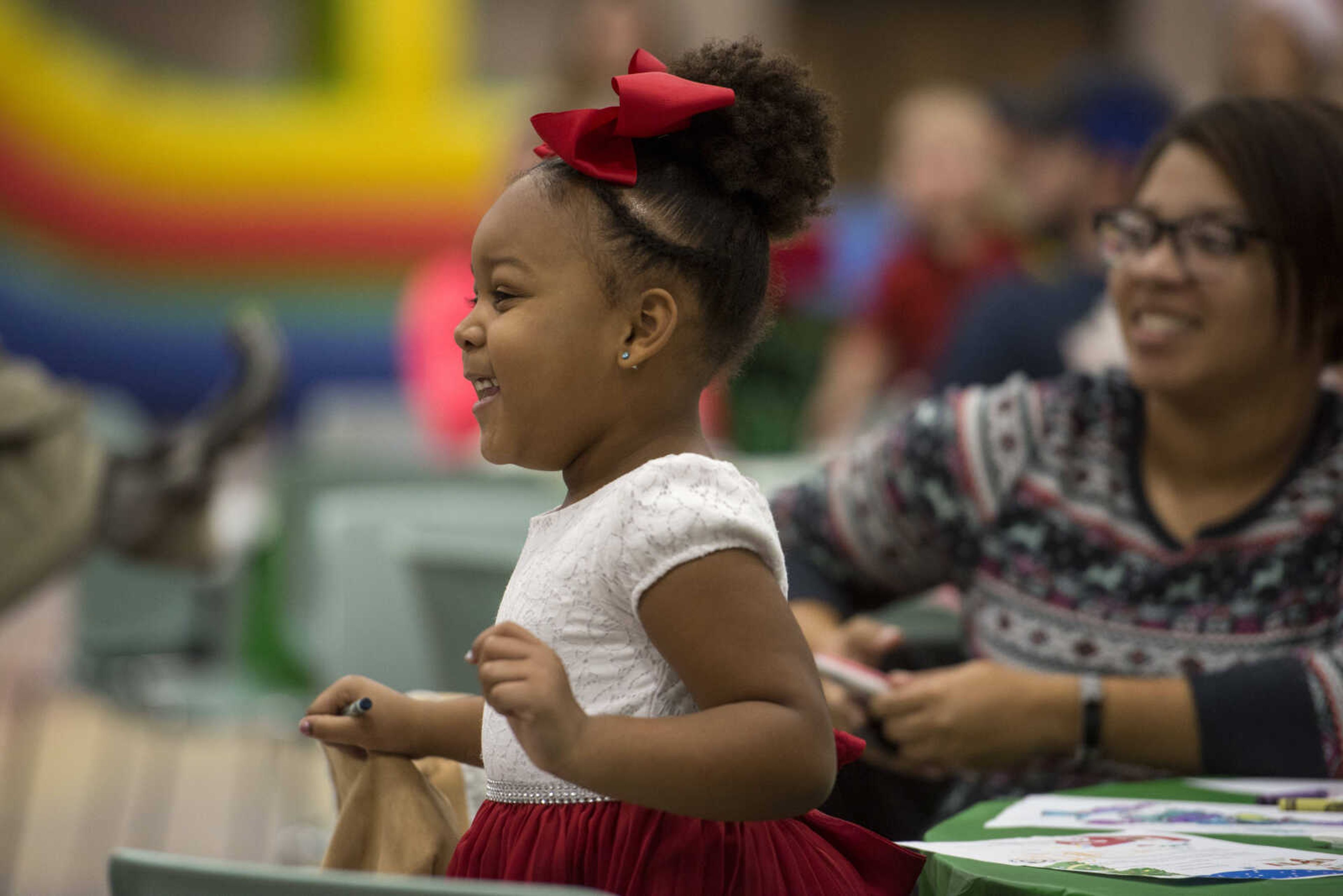 Kenzie Hinkle, 5, and Latasha Terry watch as Santa Claus enters during a family breakfast at the Osage Center Saturday, Dec. 15, 2018.