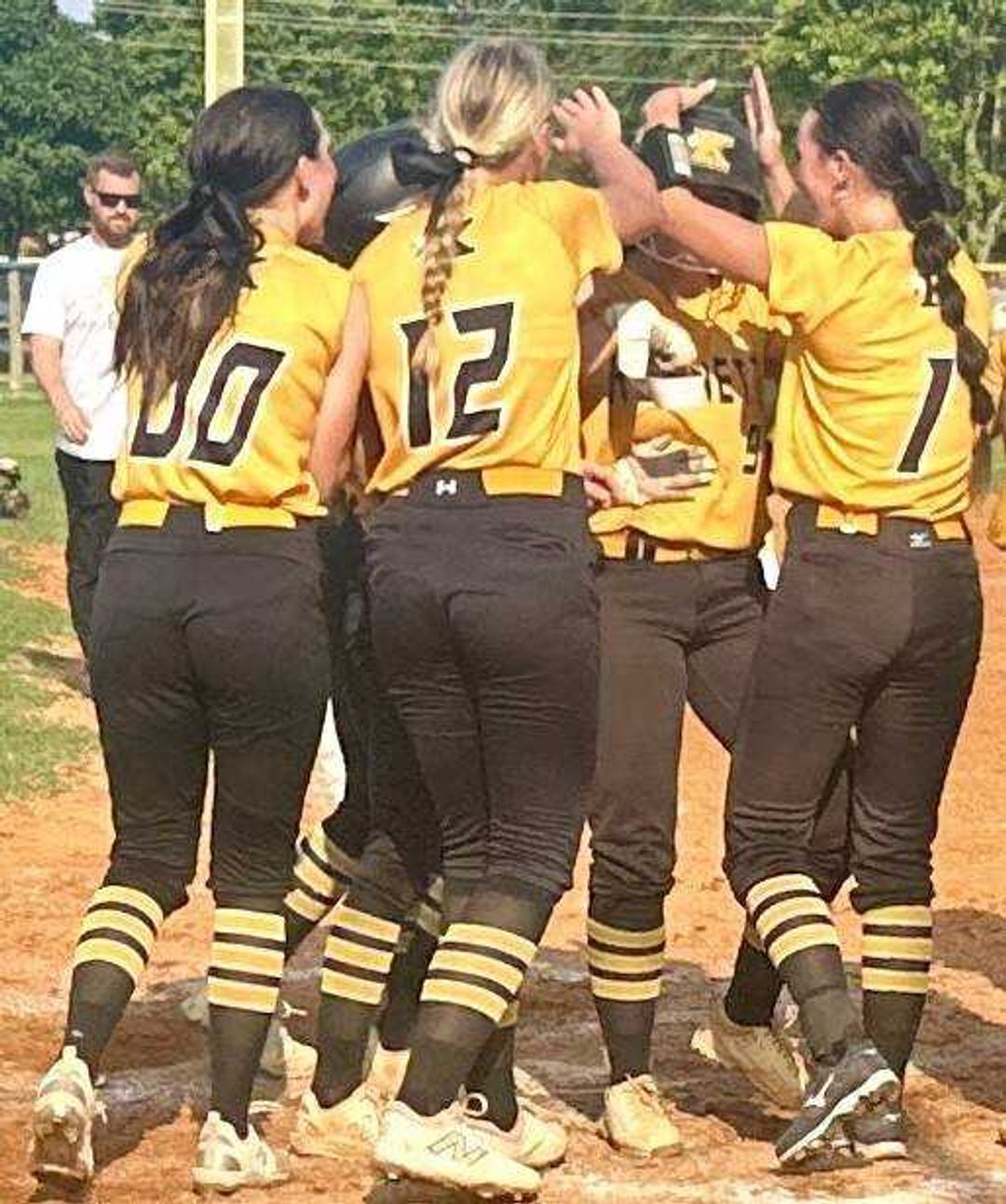 Kennett Lady Indians party at the plate with teammate Kynsly McCaig as she crosses home after her three-run shot over the left field fence Monday at Malden.