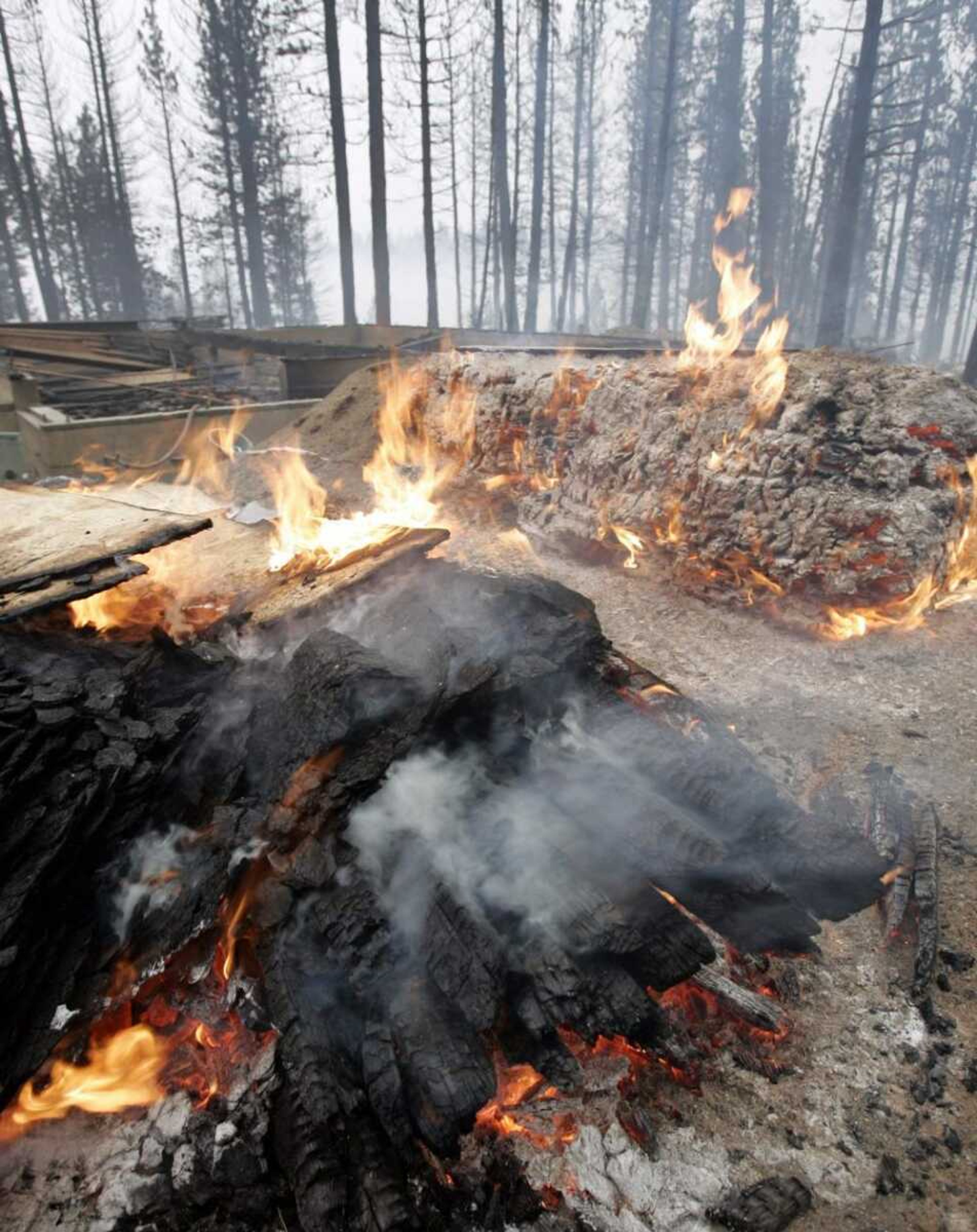 A house burned up Monday in Meyers, Calif., during a wildfire. A wind-driven forest fire burned out of control early Monday near the popular resort of Lake Tahoe, destroying more than 200 buildings and forcing about 1,000 people from their homes.<br>Paul Sakuma<br>Associated Press