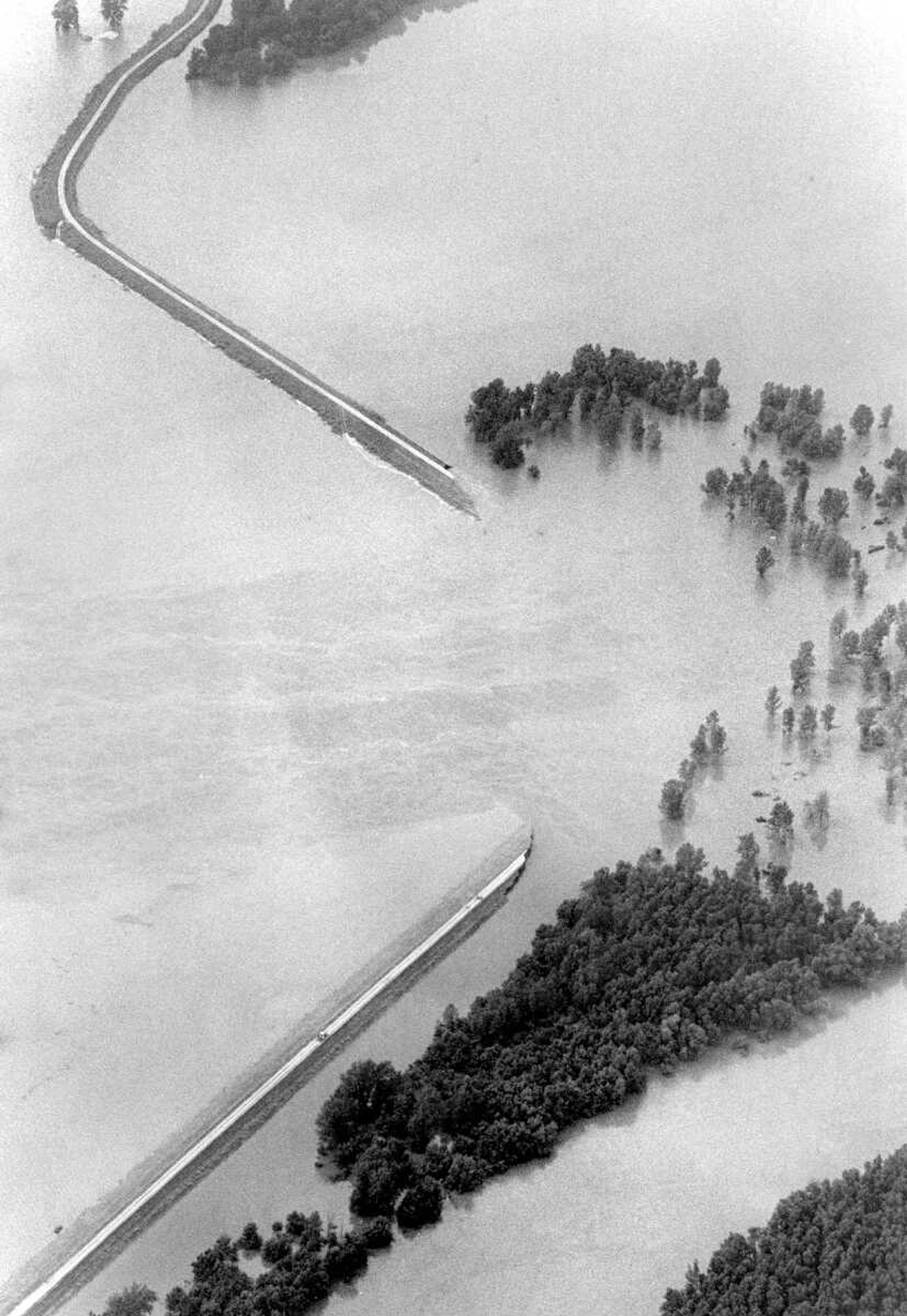 Published July 26, 1993
Mississippi River floodwaters flow through a 1,000-foot breach in the Bois Brule levee, to the left, looking north, about eight miles from McBride, Mo., and 11 miles south of the Chester (Ill.) Bridge, Sunday afternoon. About 28,000 acres of land are affected. McBride is under water. (Missourian archive photo by Fred Lynch)