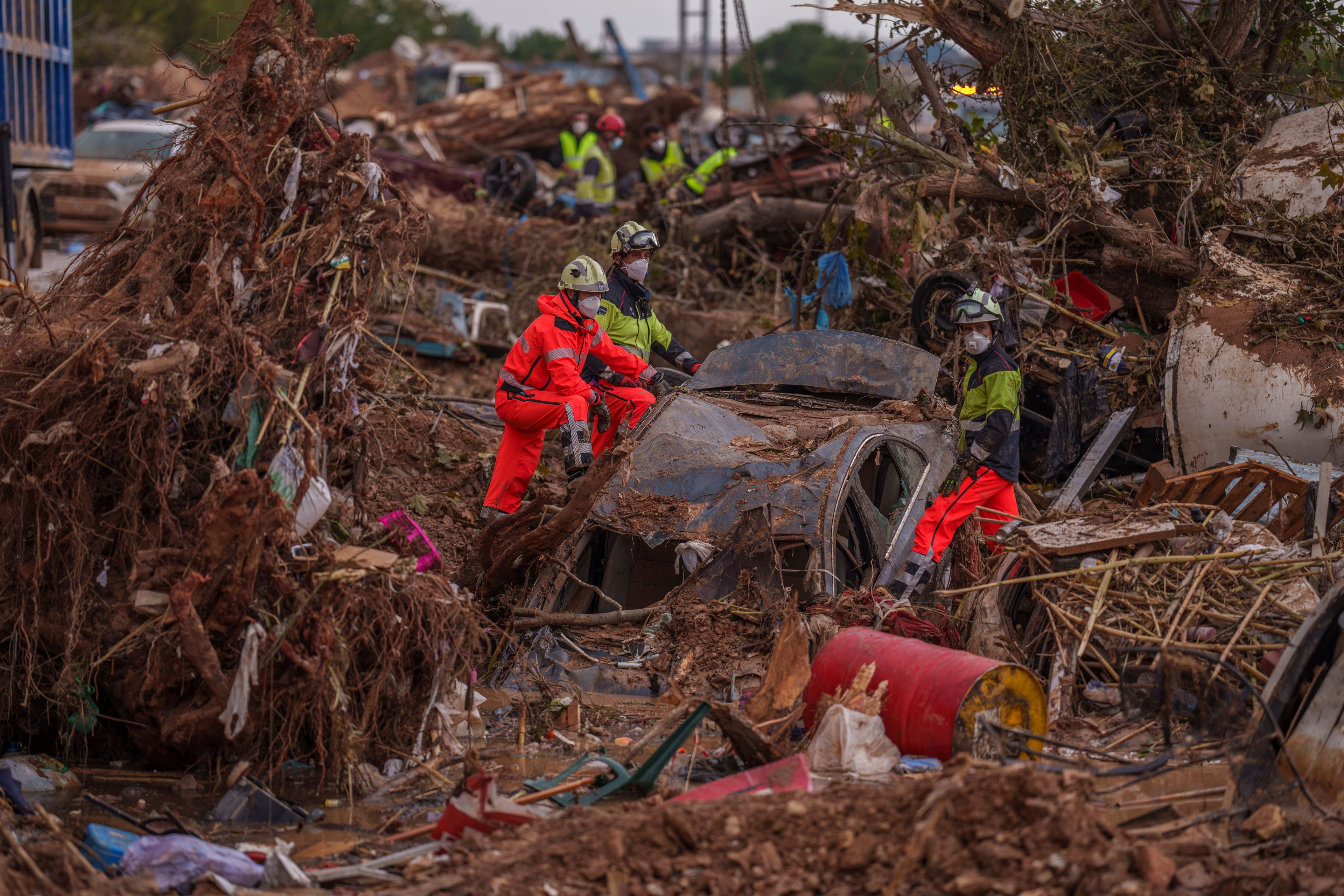 Heavy rains in Barcelona disrupt rail service as troops search for more flood victims in Valencia