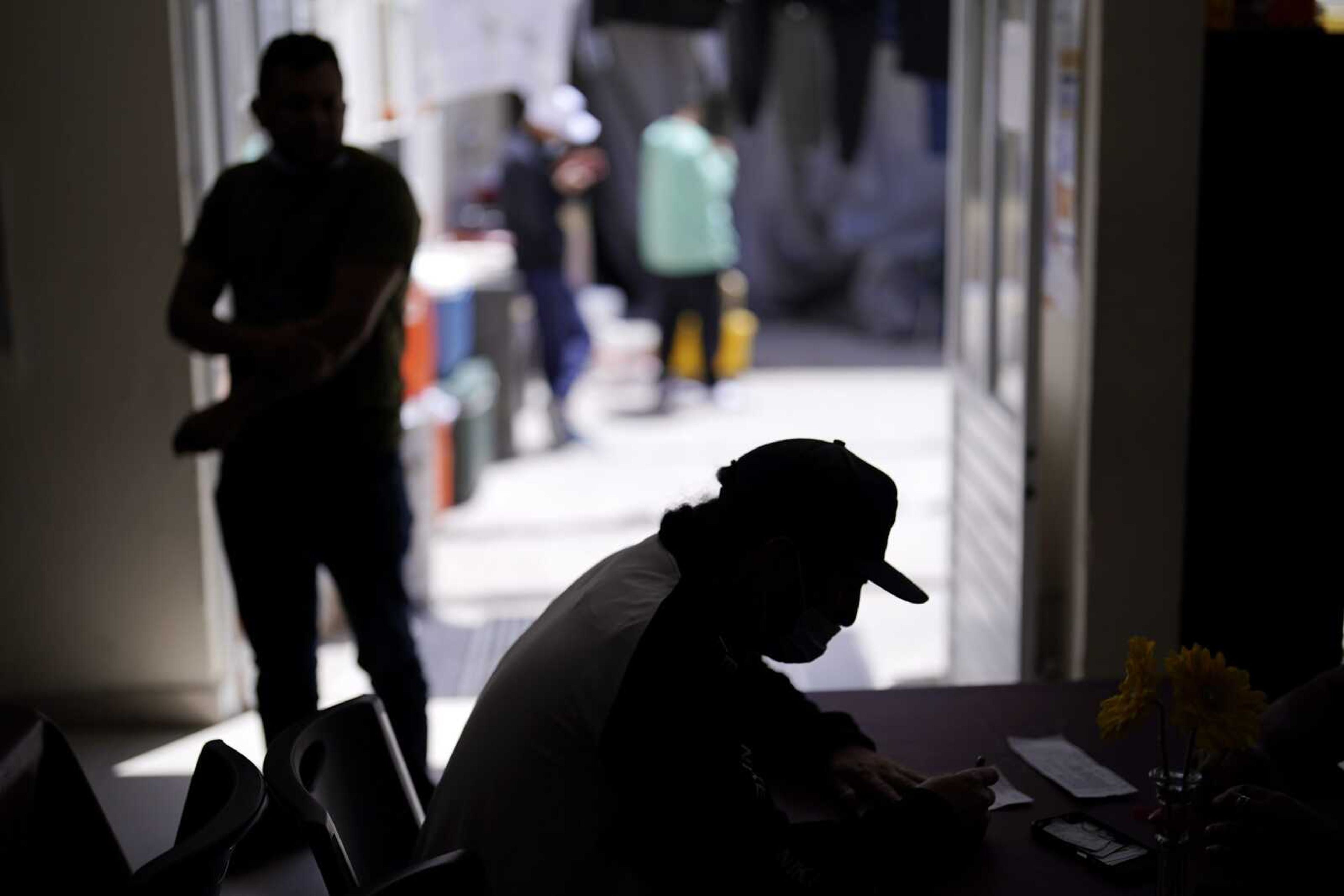 A man from Nicaragua sits at a shelter for migrants Thursday in Tijuana, Mexico. The man is waiting in Mexico for hearings in U.S. immigration court, part of a Trump-era policy that was argued Tuesday before the U.S. Supreme Court.