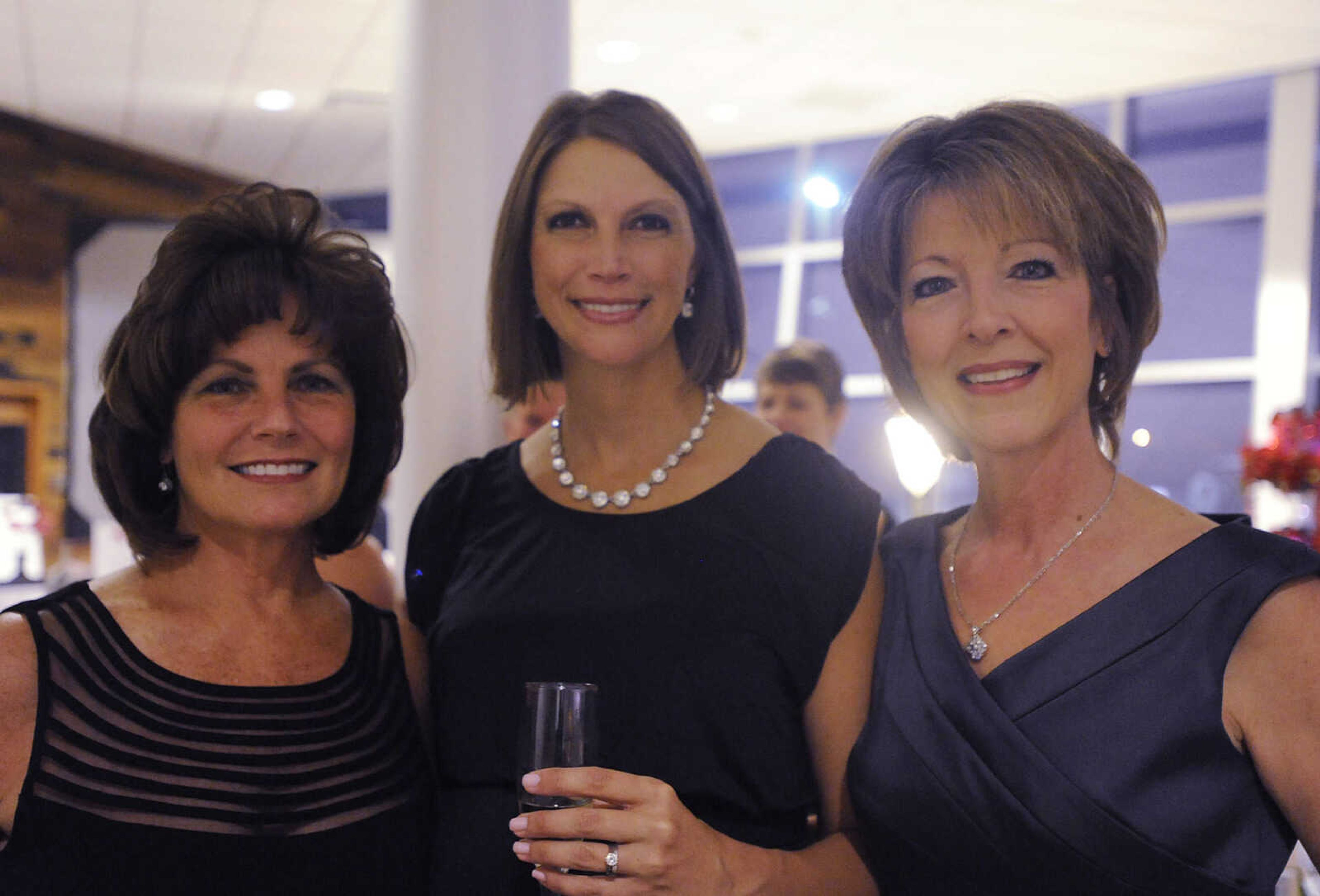 Jan Rigdon, left, Victoria Moon and Debbie Smith at a black tie fundraiser for the Tailor Institute Saturday, October 27, at the Southeast Cancer Center. The Tailor Institute helps individuals diagnosed with autism identify and use their special skills and learn to work and live independently. Dr. David Crowe, whose son Taylor is high-function on the autism spectrum, founded the institute in 2003.