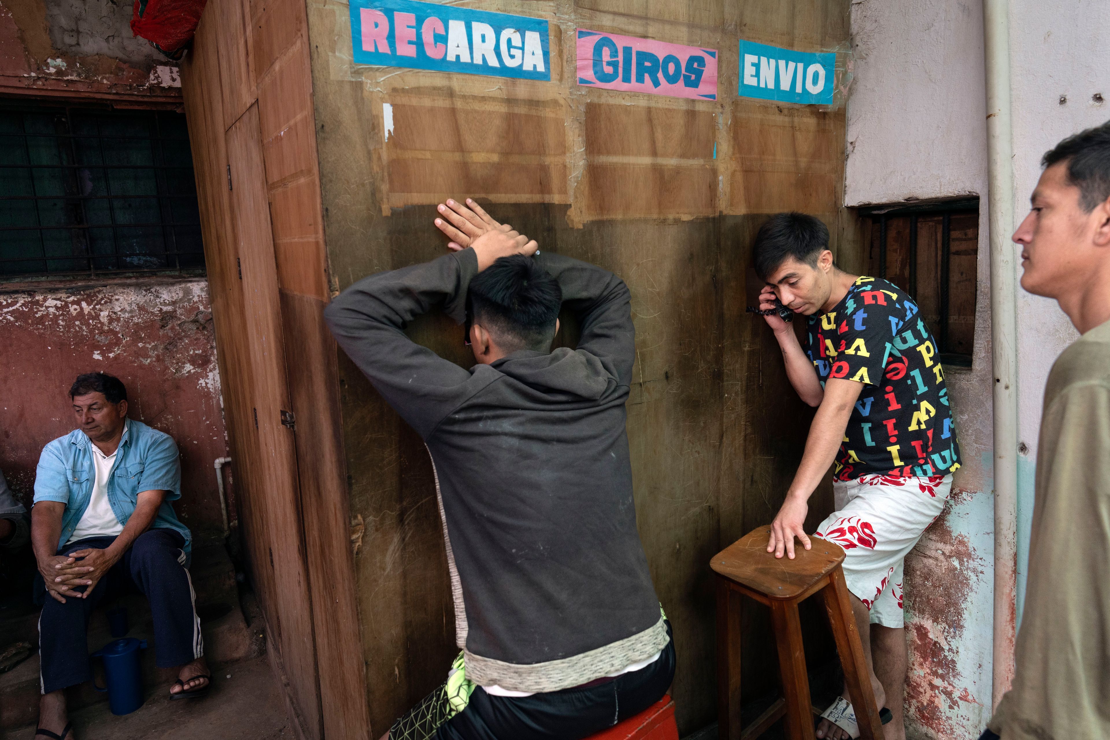 Inmates use a pay-by-the-minute phone booth set up and run by prisoners at the Regional Penitentiary in Villarica, Paraguay, Saturday, Aug. 31, 2024. Most inmates' calls get paid for by their families when they come to visit in person. (AP Photo/Rodrigo Abd)