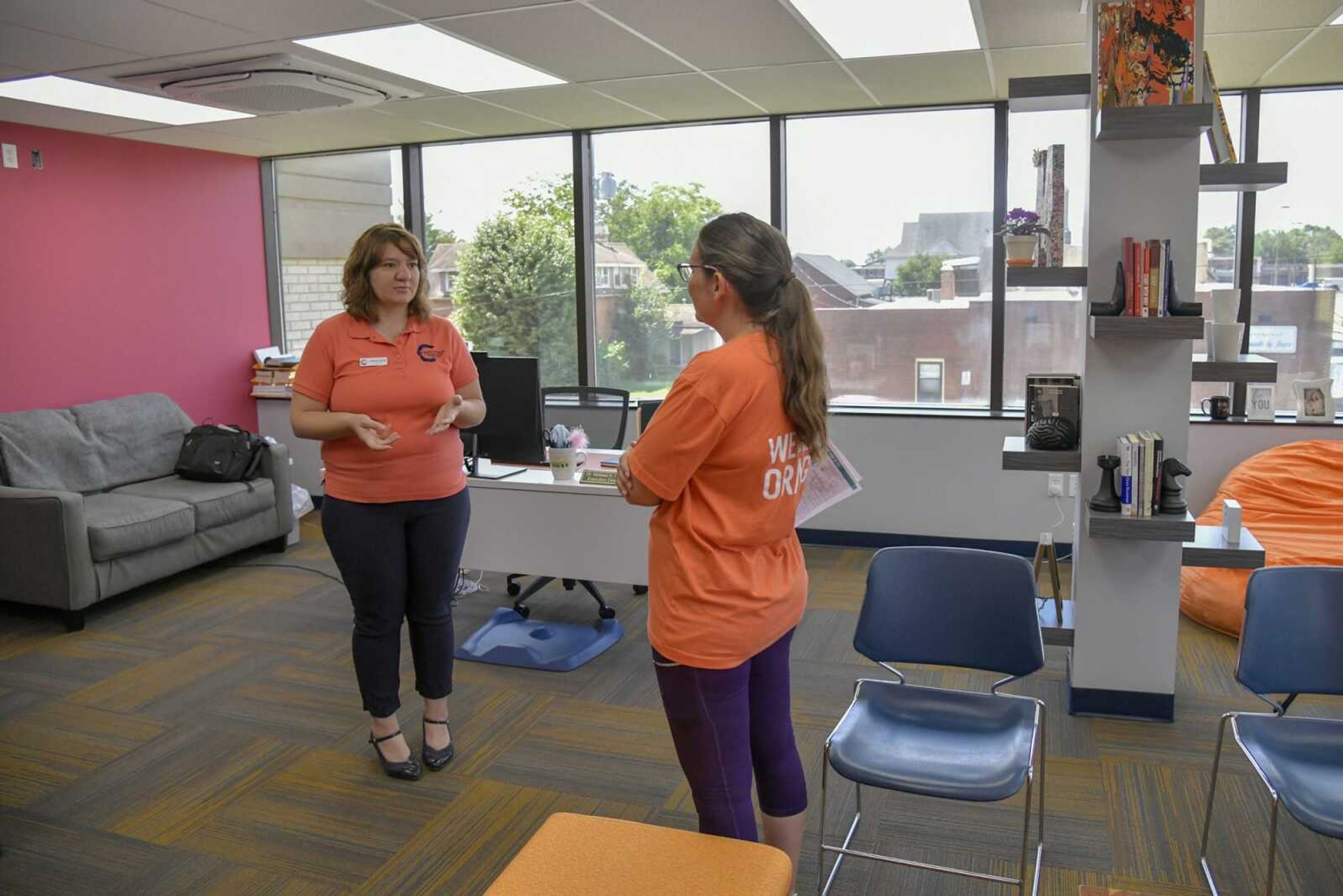 Executive director Melissa Stickel speaks to a guest in her new office during the Community Partnership of Southeast Missouri open house event June 4 in Cape Girardeau.