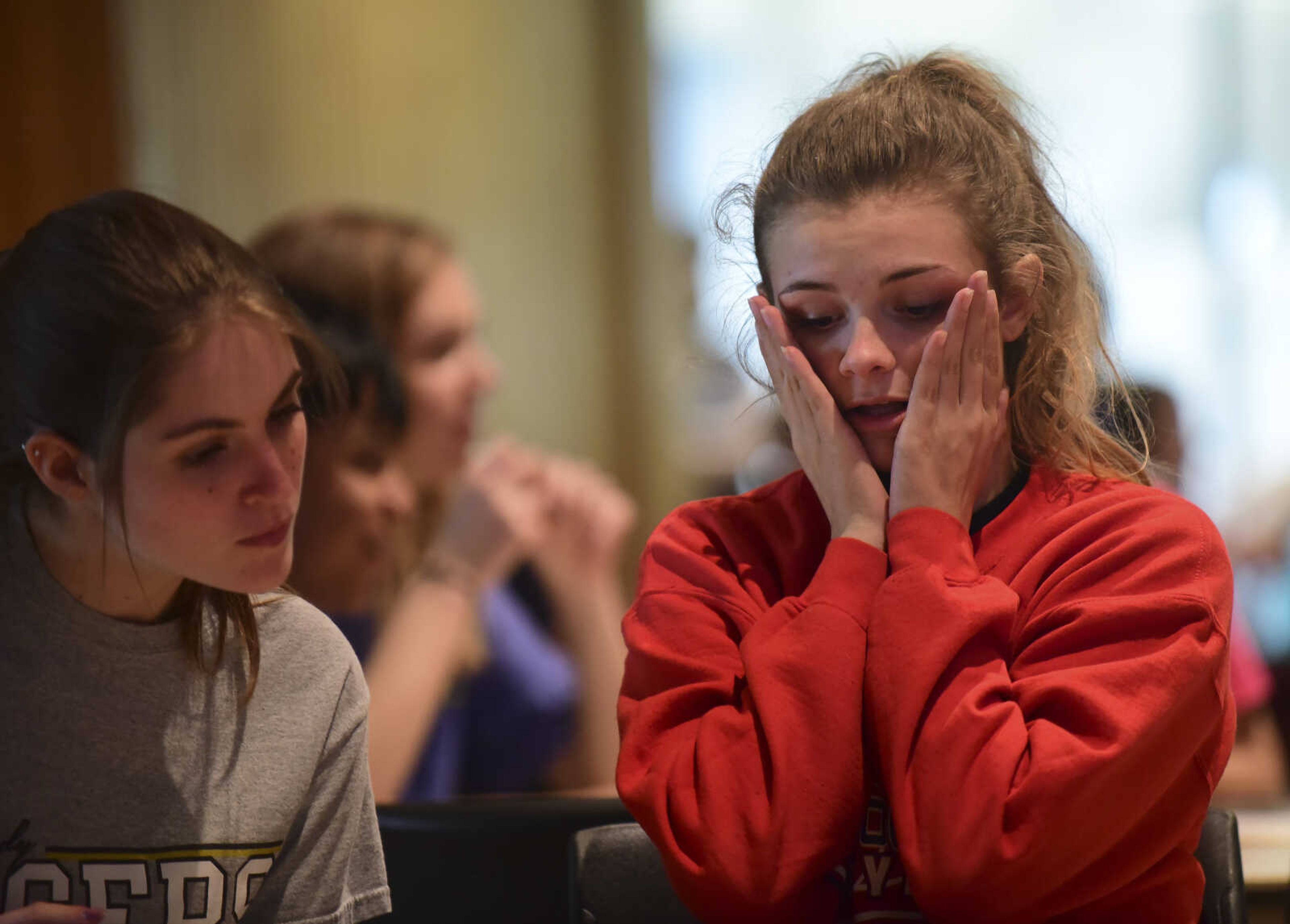 Brianna Landrum, right, holds her face while she works with Britney Menley, left, from Arcadia Valley in the problem-solving event during the 40th annual Math Field Day Tuesday, April 18, 2017 at the University Center on the campus of Southeast Missouri State University in Cape Girardeau.