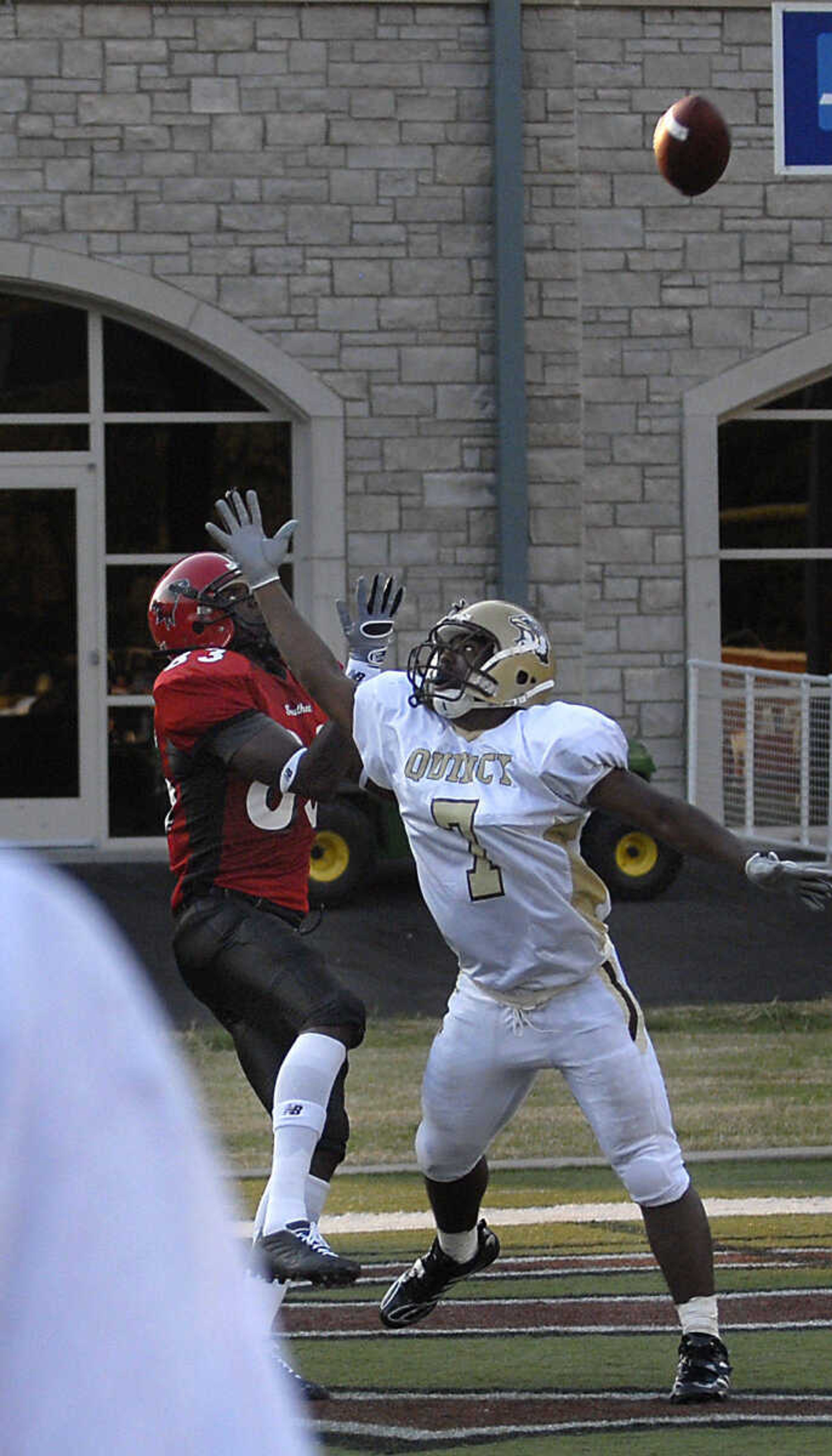 KIT DOYLE ~ kdoyle@semissourian.com
Chantae Ahamefule pulls in a touchdown over Quincy defender Cyele Wiemer Thursday, September 3, 2009, in the season opener at Houck Stadium.