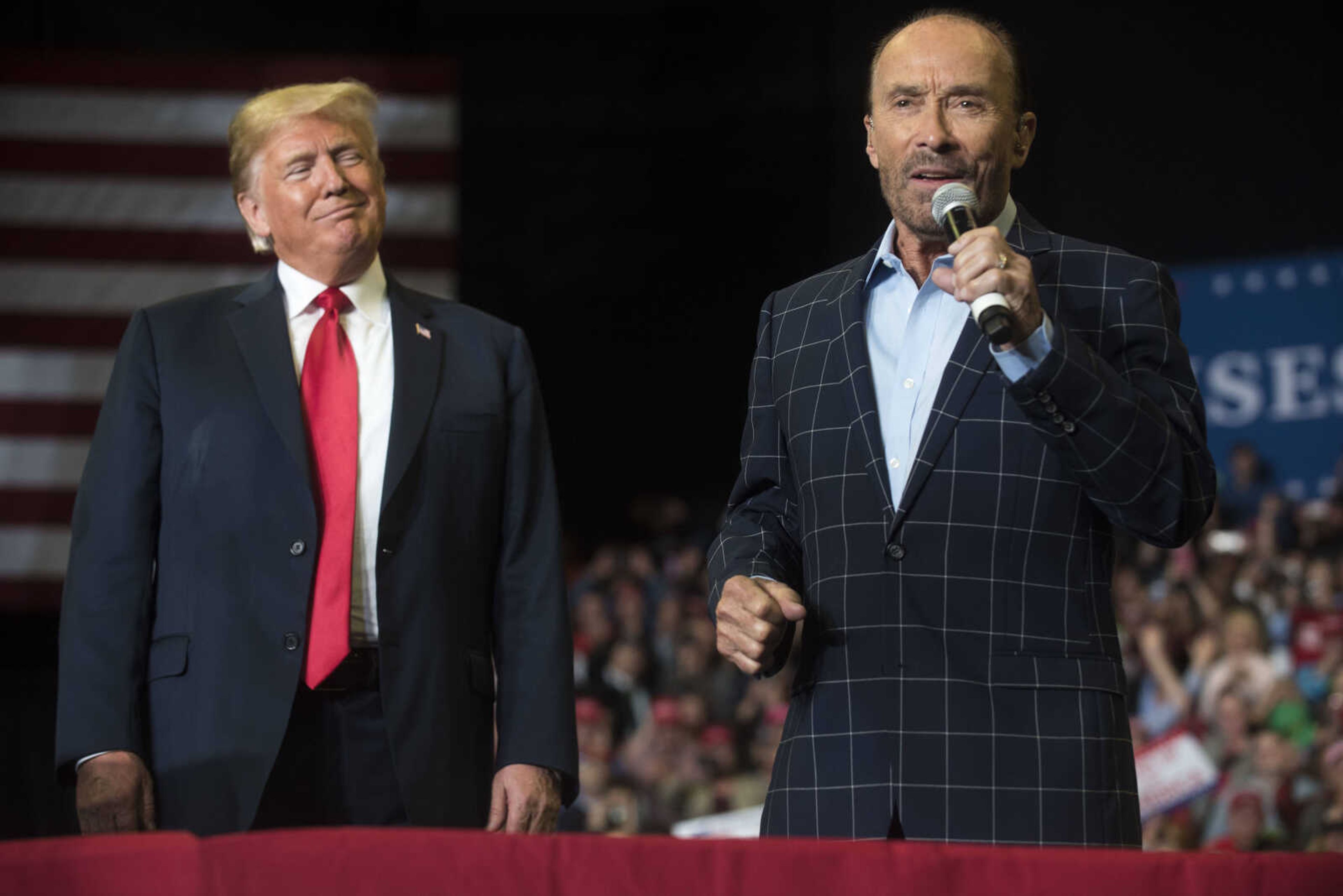 President Donald Trump listens as country musician Lee Greenwood sings "God Bless the USA" during a Make America Great Again rally Monday, Nov. 5, 2018, at the Show Me Center in Cape Girardeau.