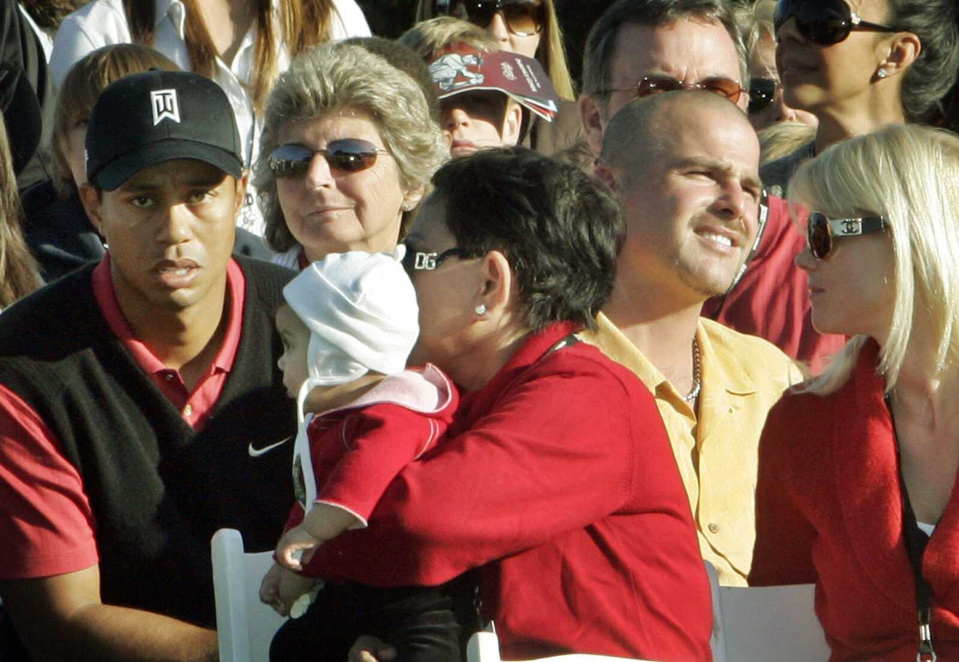 Tiger Woods sat with his mother Kultida and his infant daughter Sam Alexis as he waited for the trophy ceremony Sunday  at the  Target World Challenge at Sherwood Country Club in Thousand Oaks, Calif. (REED SAXON ~ Associated Press)