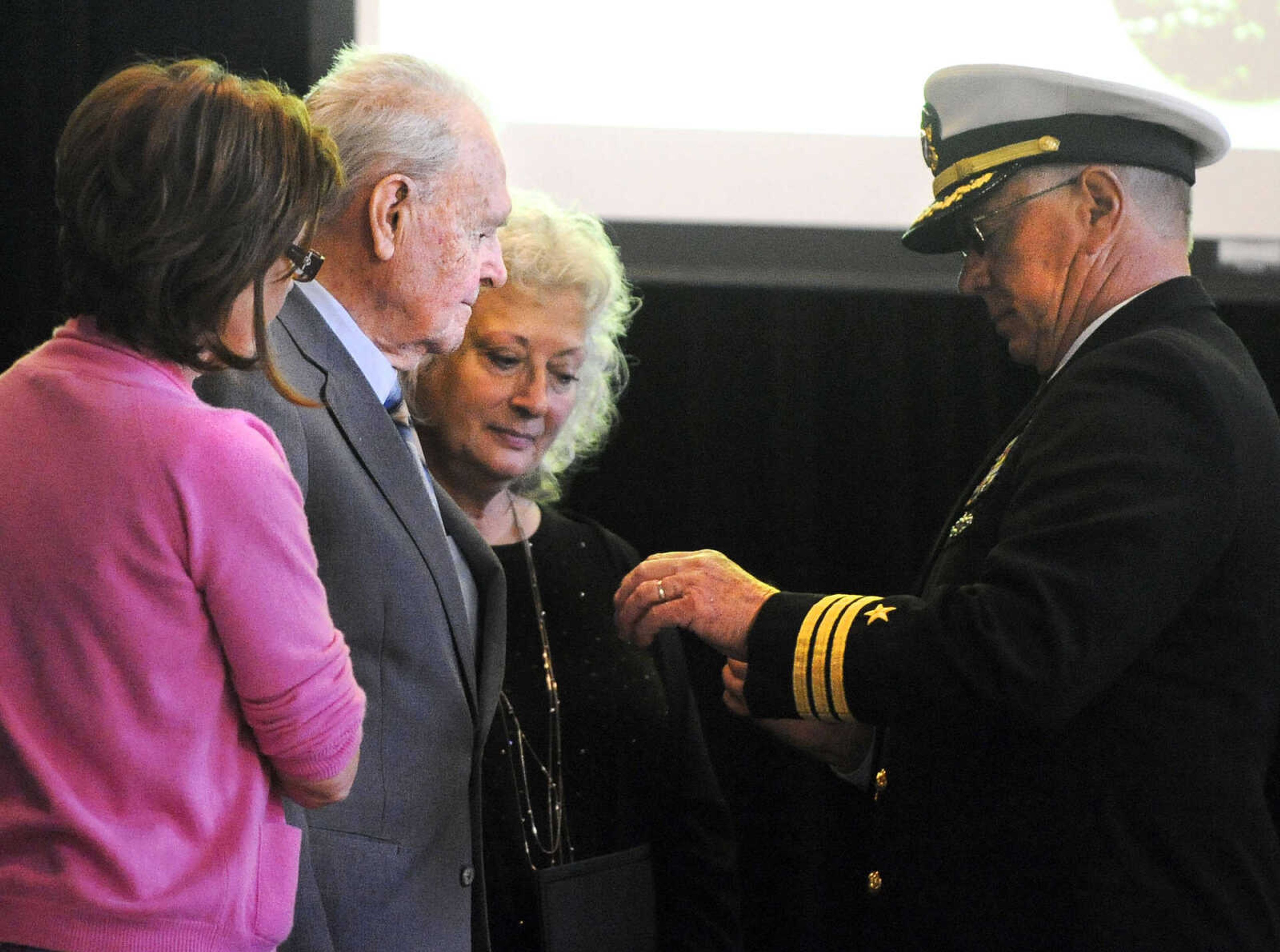 LAURA SIMON ~ lsimon@semissourian.com

Retired U. S. Navy Commander Lawson Burgfeld, right, presents U.S. Army Air Corps veteran Sgt. Clifford Heinrich with a European-African-Middle Eastern Campaign Medal with Bronze Star on Monday, March 21, 2016, at Alma Schrader Elementary in Cape Girardeau. Heinrich was also presented with an American Campaign Medal, WWII Victory Medal, Army Good Conduct Medal, a WWII Lapel Button and the Purple Heart for his service during WWII. Pictured with Heinrich are Diane Gomersall, left, and Linda Thompson.