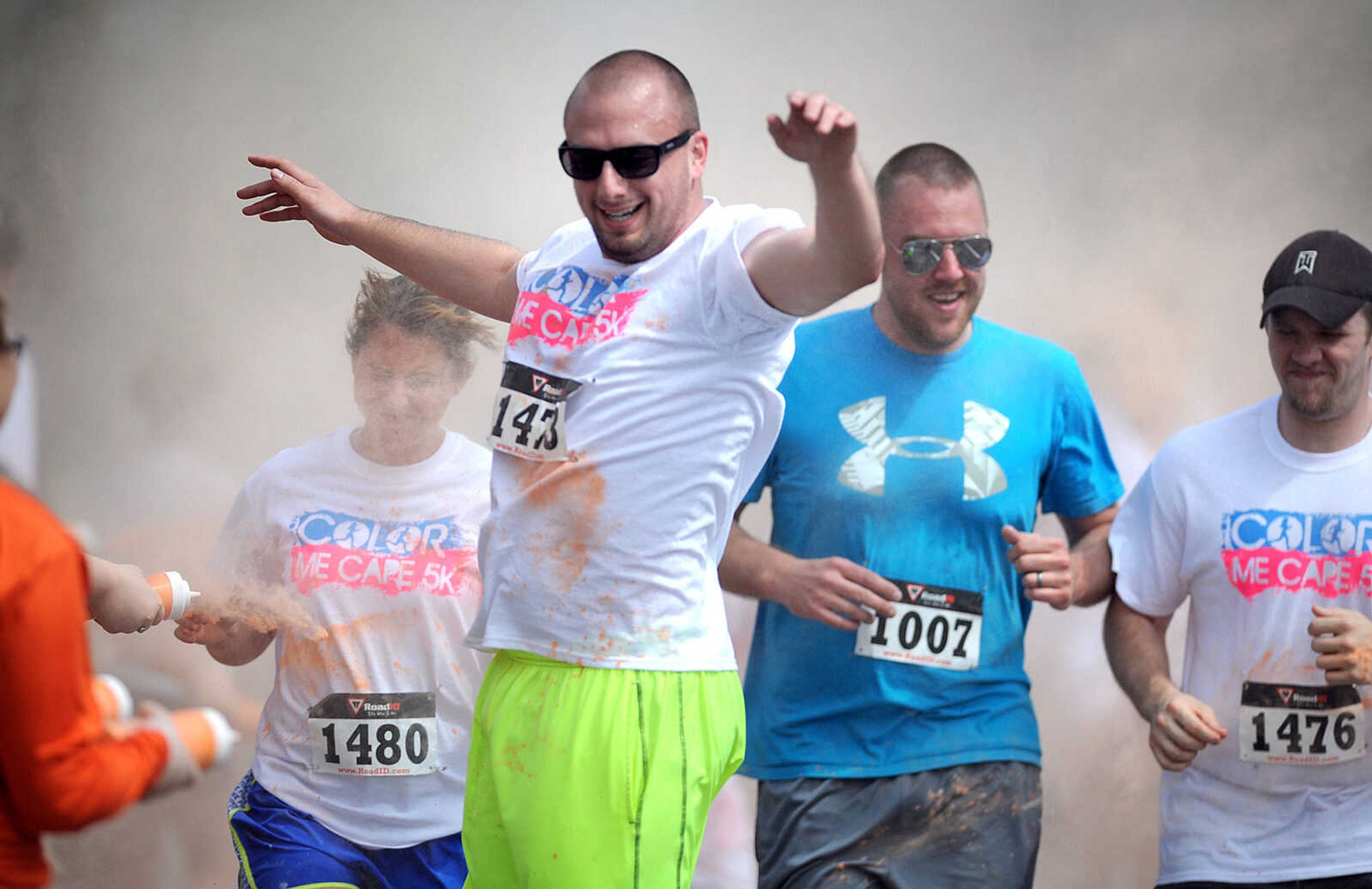 LAURA SIMON ~ lsimon@semissourian.com

Participants in the Color Me Cape 5K are sprayed with orange powder at the first color station on Good Hope Street, Saturday, April 12, 2014, in Cape Girardeau.