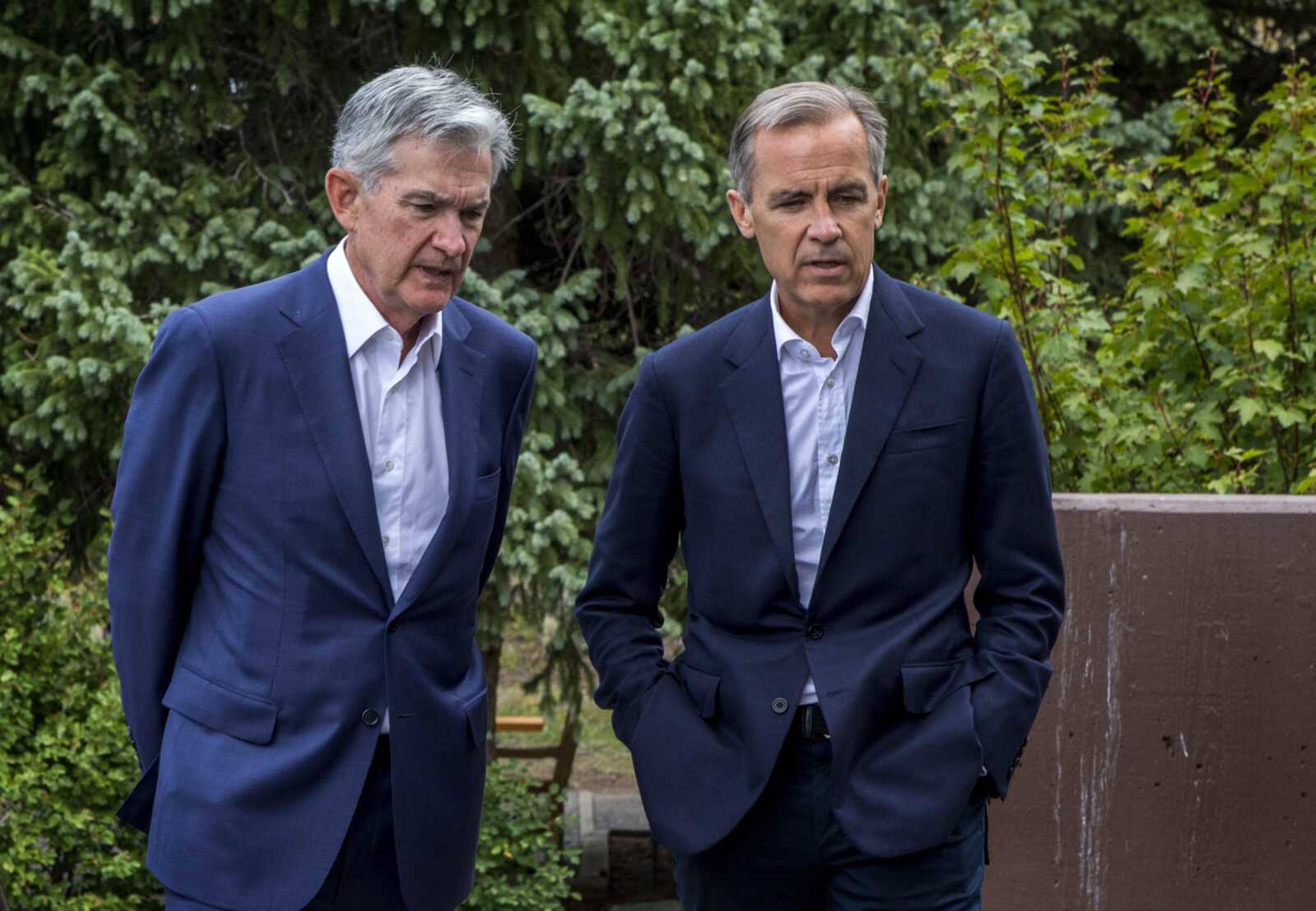 Federal Reserve chairman Jerome Powell, left, and Bank of England governor Mark Carney, right, walk together after Powell's speech at the Jackson Hole Economic Policy Symposium on Friday in Jackson Hole, Wyoming.