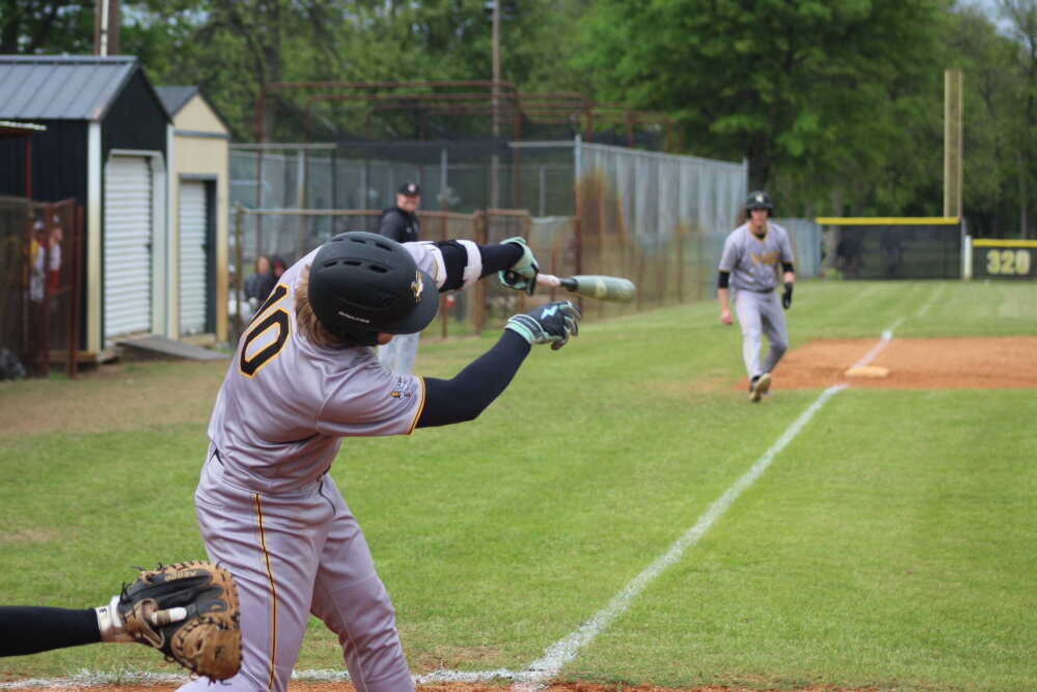 Kennett's Ashton Williams swings for the cheap seats at a regular season game at Indian Park.