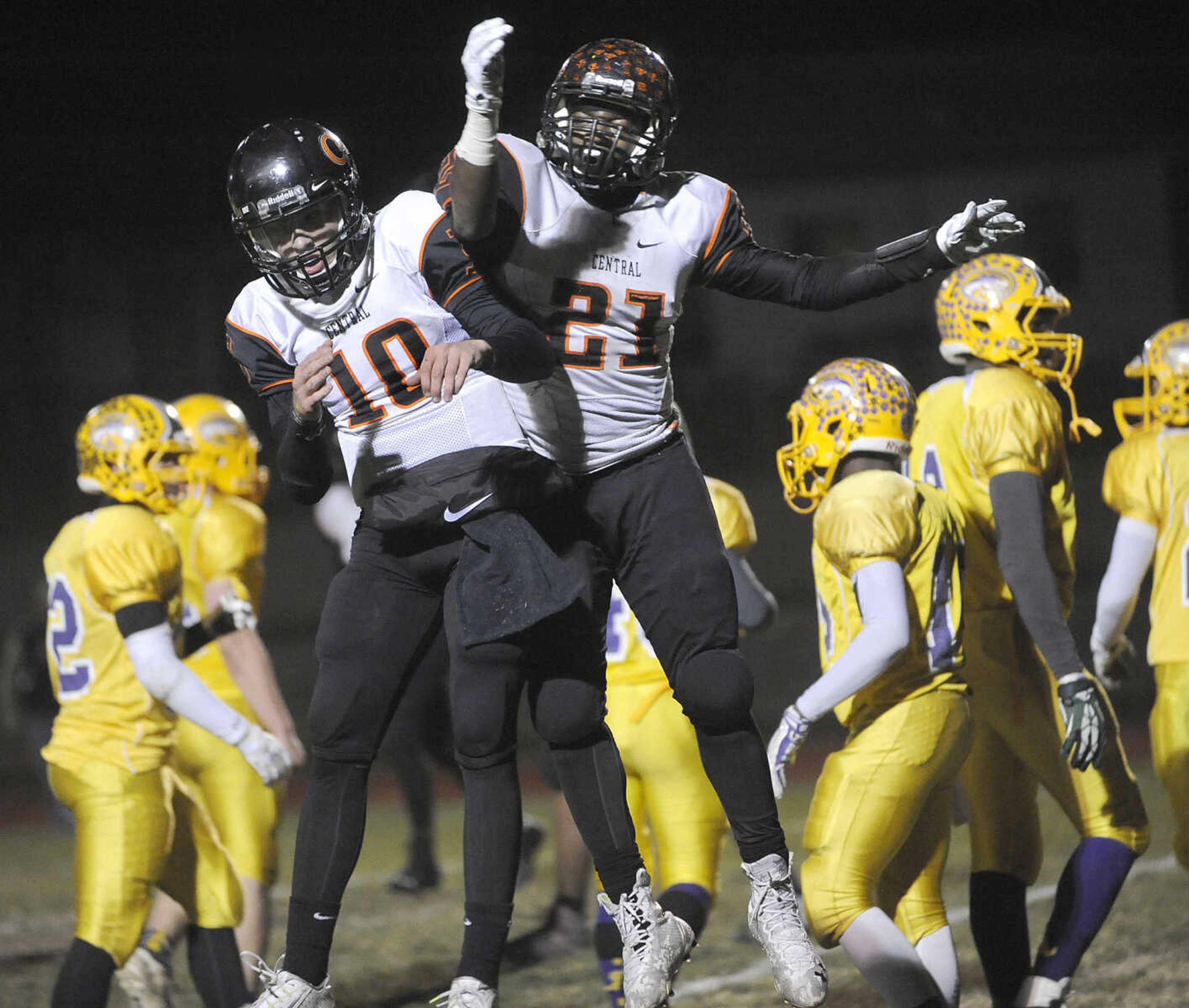 Central running back Braion Owens, right, celebrates with quarterback Peyton Montgomery after Owens scored the second touchdown against Affton during the first quarter of the Class 4 state quarterfinal Friday, Nov. 14, 2014 in Affton, Missouri. (Fred Lynch)