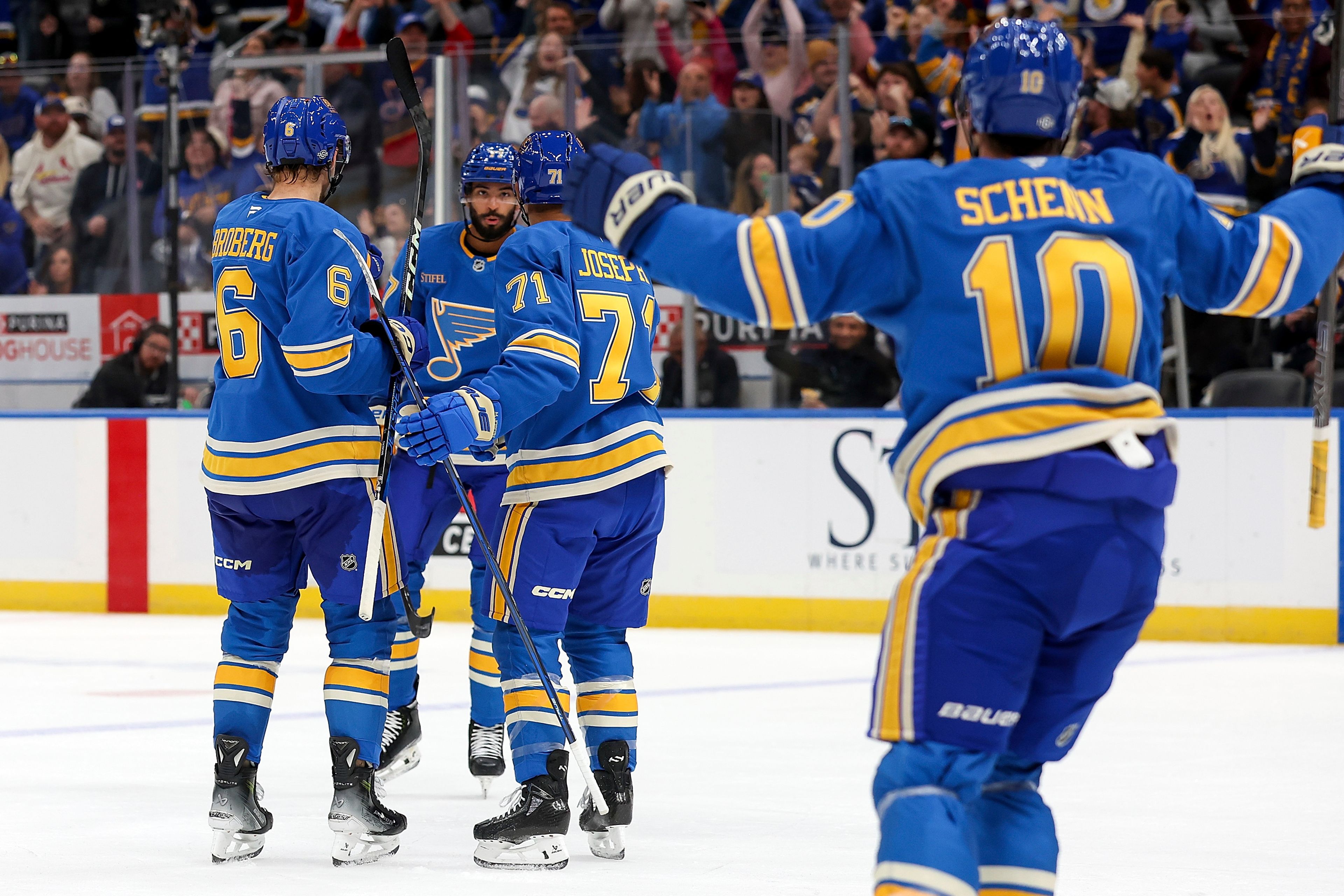 St. Louis Blues' Mathieu Joseph (71) celebrates with teammates after scoring a goal during the second period of an NHL hockey game against the Carolina Hurricanes, Saturday, Oct. 19, 2024, in St. Louis. (AP Photo/Scott Kane)