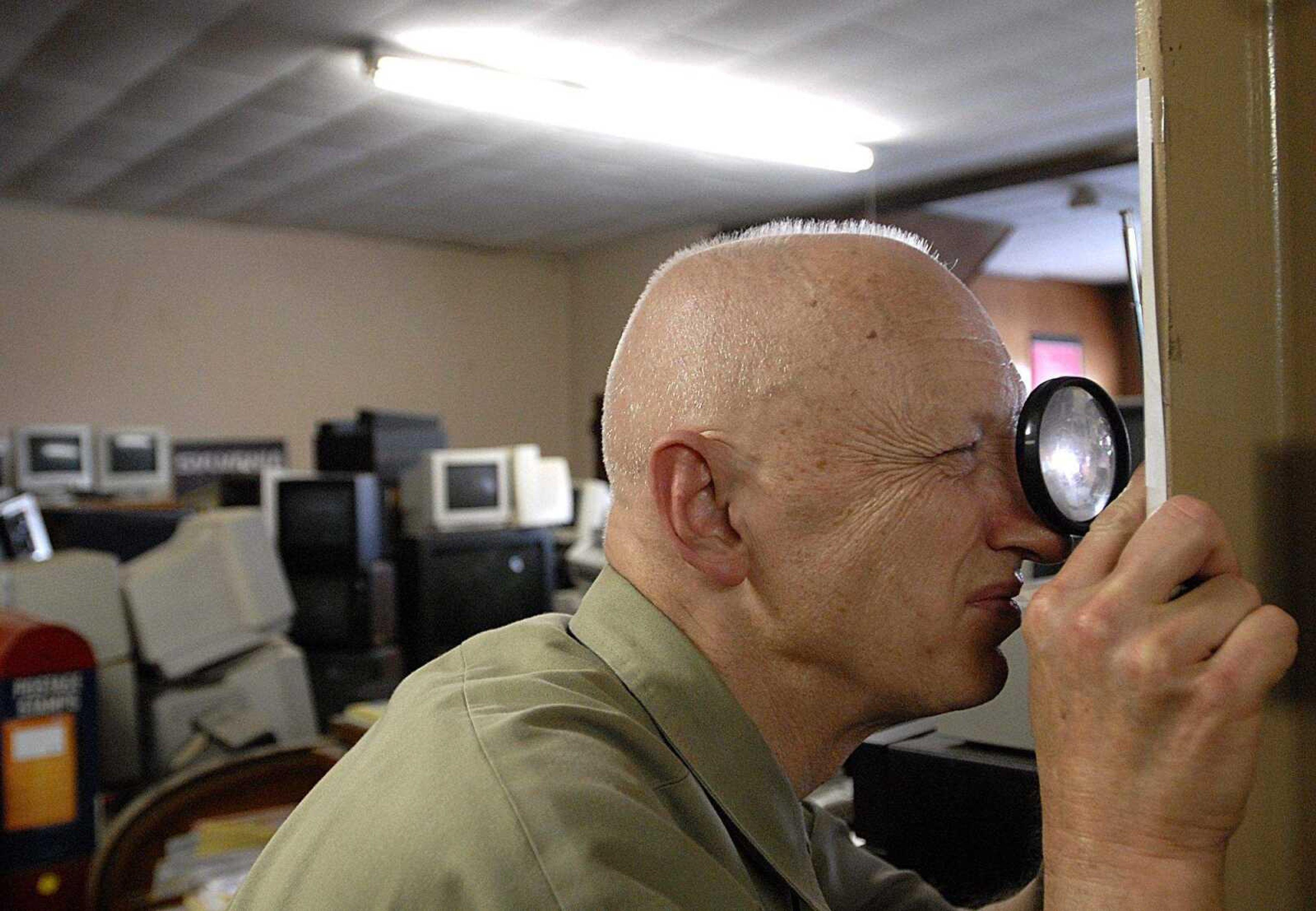 AARON EISENHAUER ~ aeisenhauer@semissourian.com
Joe Lorberg uses a magnifying glass to reference a chart as he looks up the sales tax on a television set on Monday, June 9, 2008.