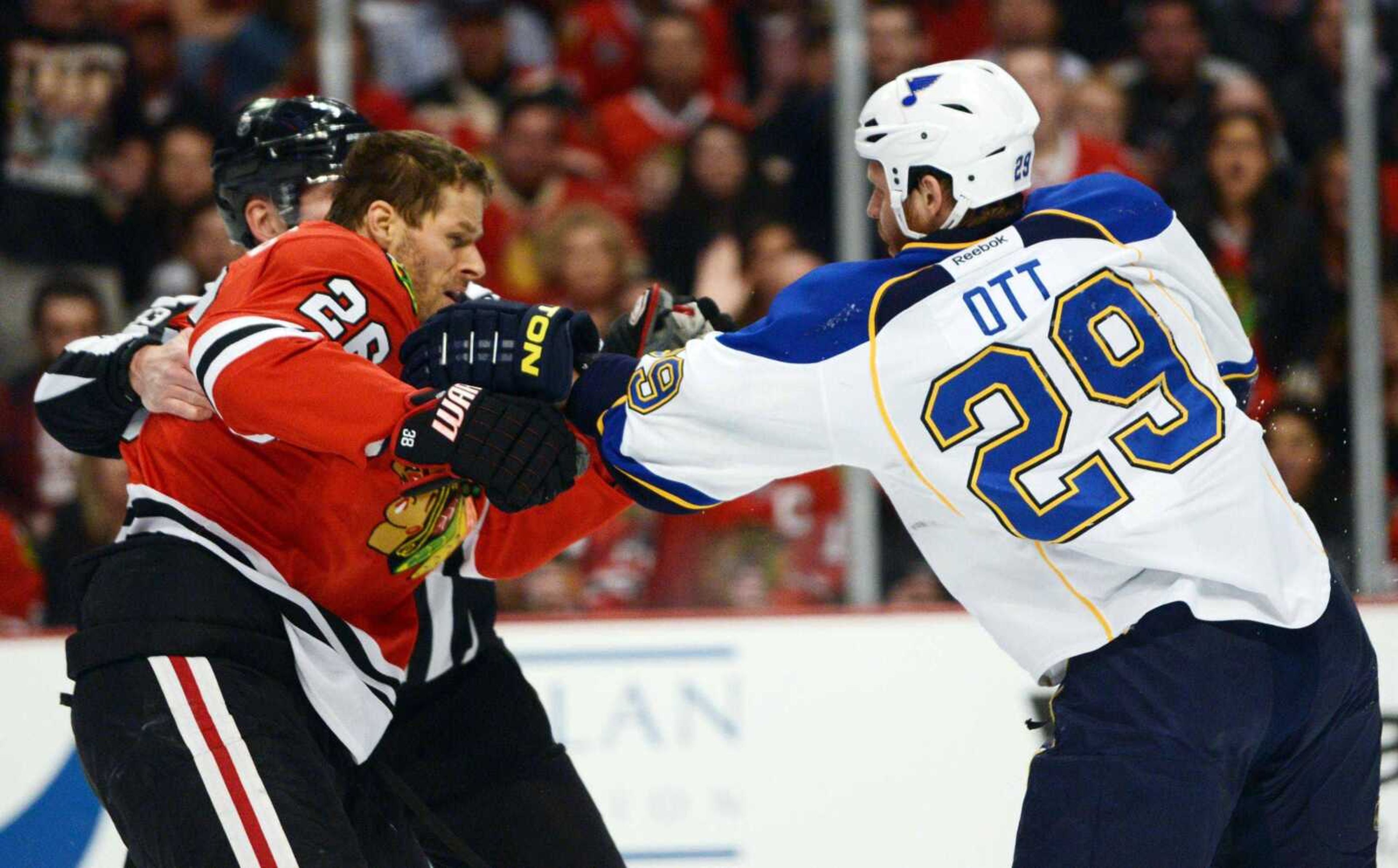 Blackhawks center Michal Handzus and St. Louis Blues center Steve Ott fight during Game 4 of their NHL first-round playoff series Wednesday in Chicago. The Blackhawks won 4-3 in overtime to even the series at 2-2. (John Starks ~ Associated Press)