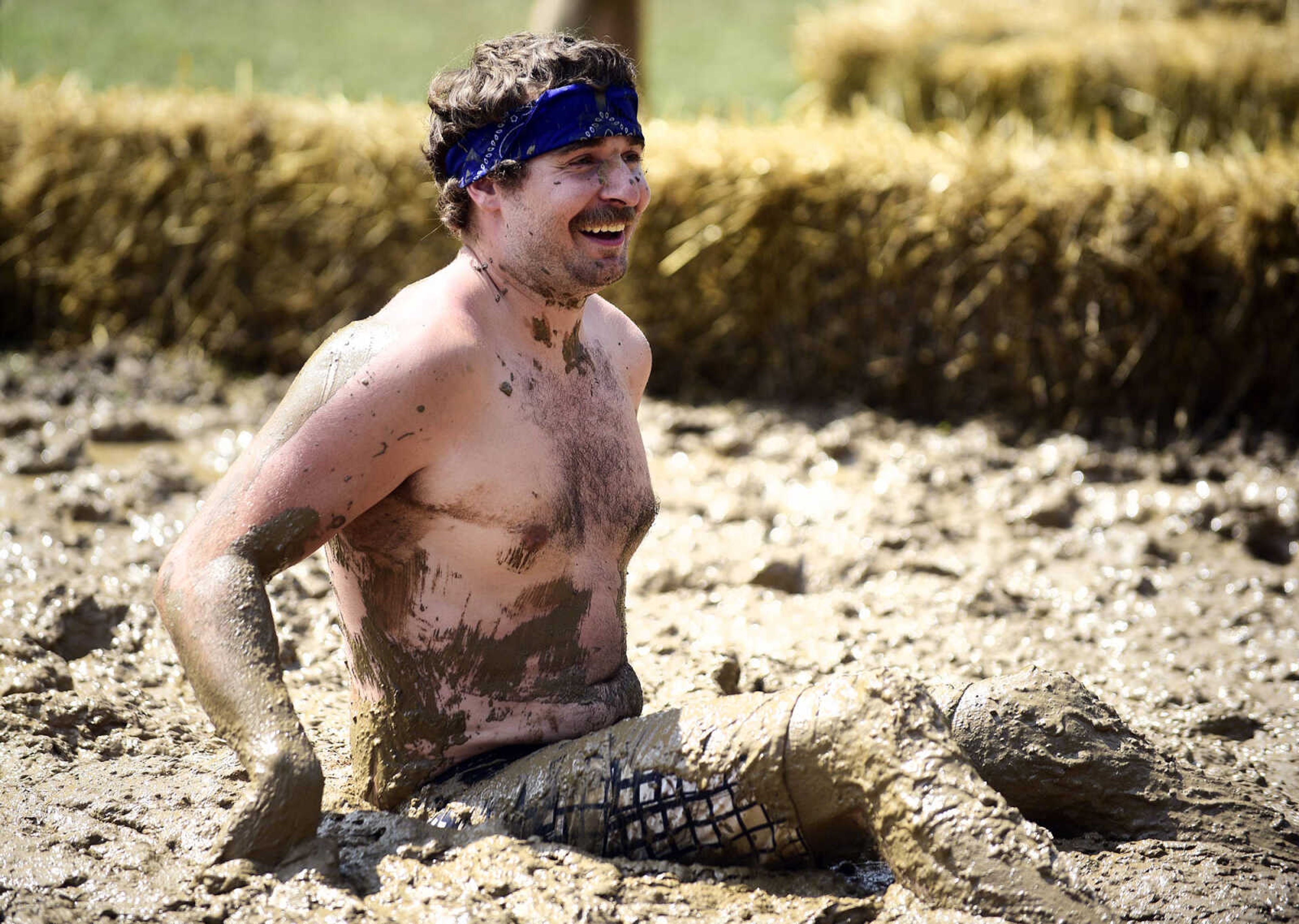 Skyler Kempf plops in the mud during a play during the Fourth of July celebration on Tuesday at Jackson City Park.