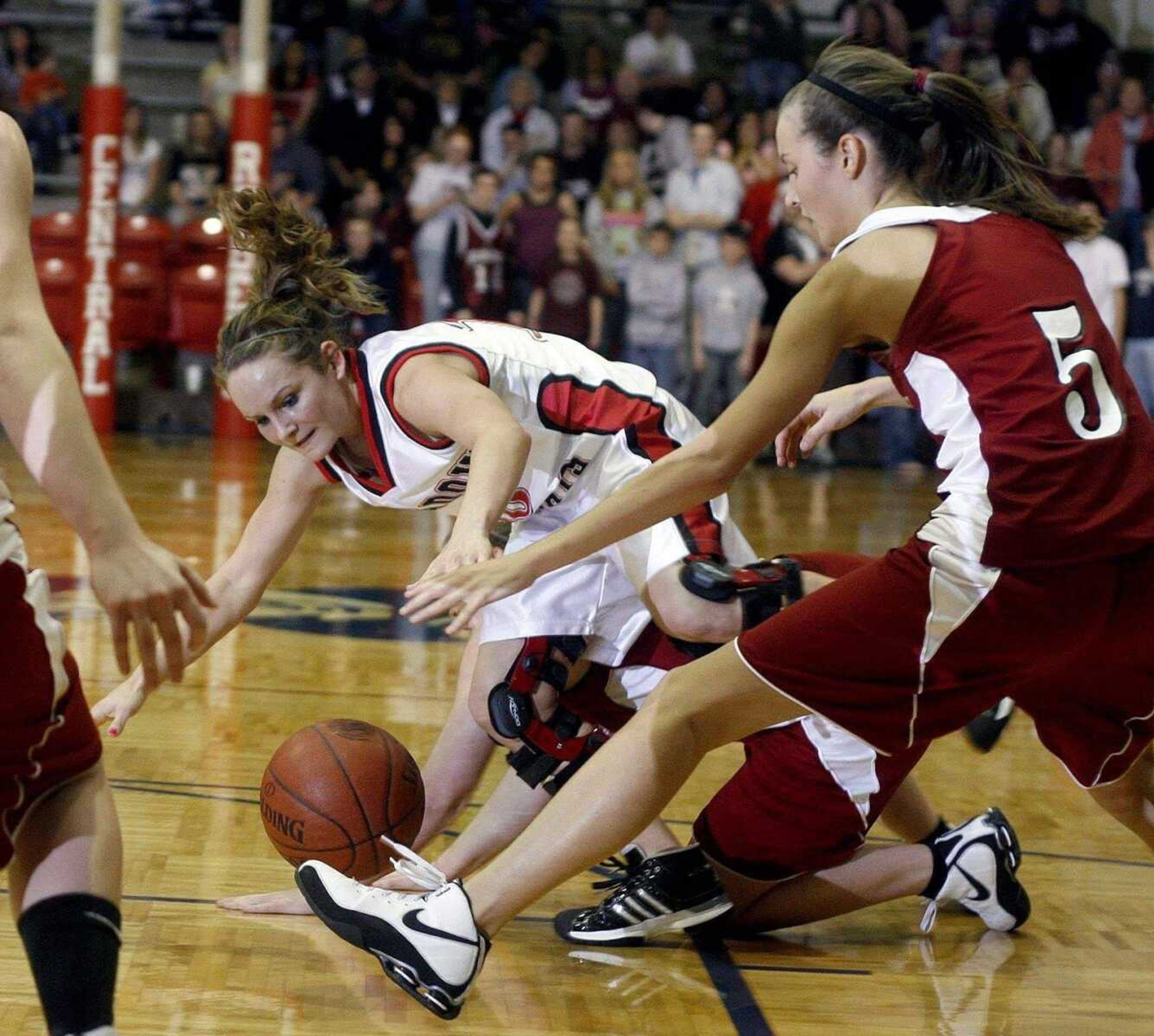 Meadow Heights' Gina Cureton jumps for a loose ball during the second half Wednesday night in Park Hills.