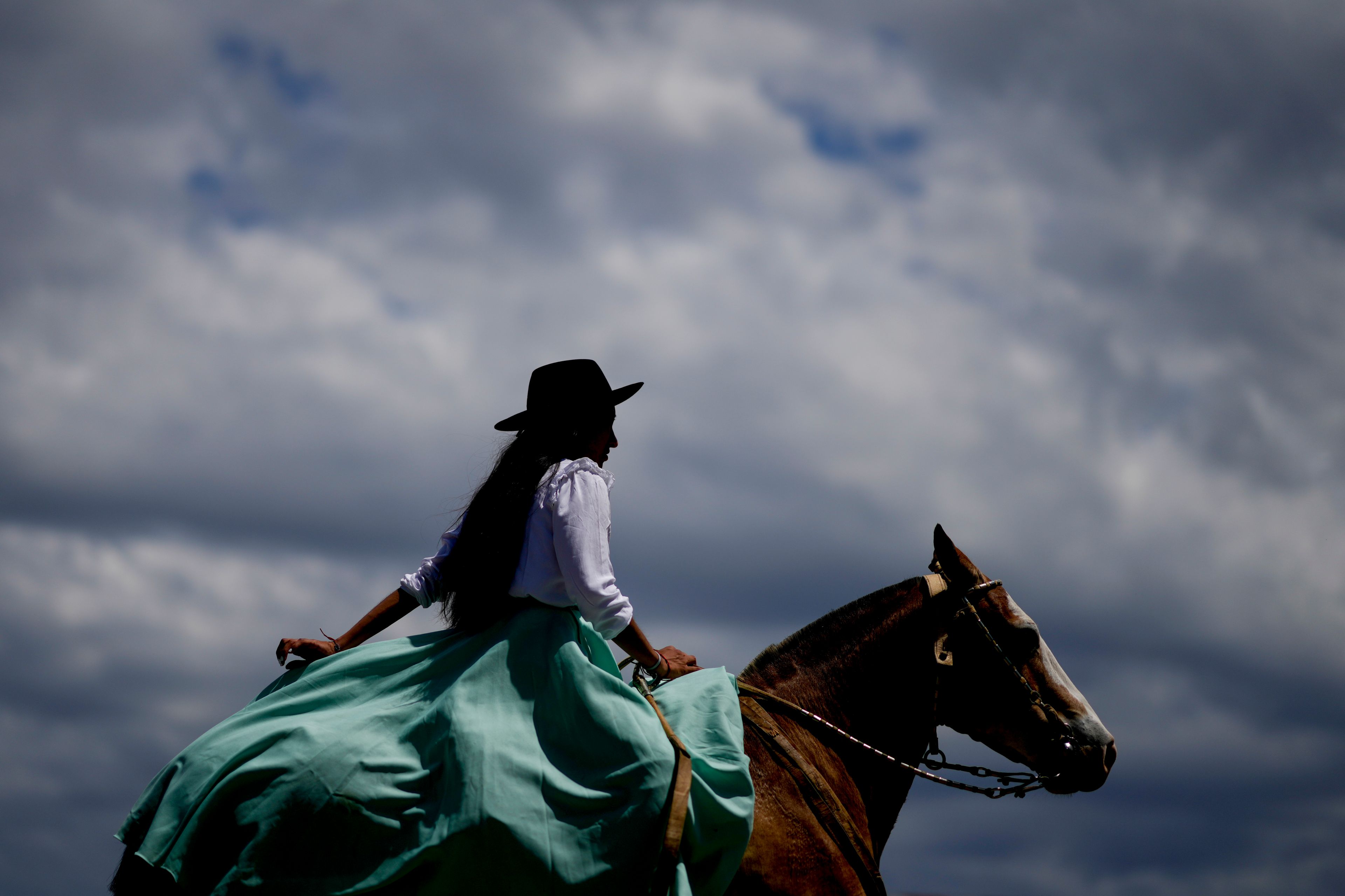 A woman rides a horse during Tradition Day, aimed to preserve gaucho culture and celebrate the birth of writer Jose Hernandez, in San Antonio de Areco, Argentina, Sunday, Nov. 10, 2024. (AP Photo/Natacha Pisarenko)