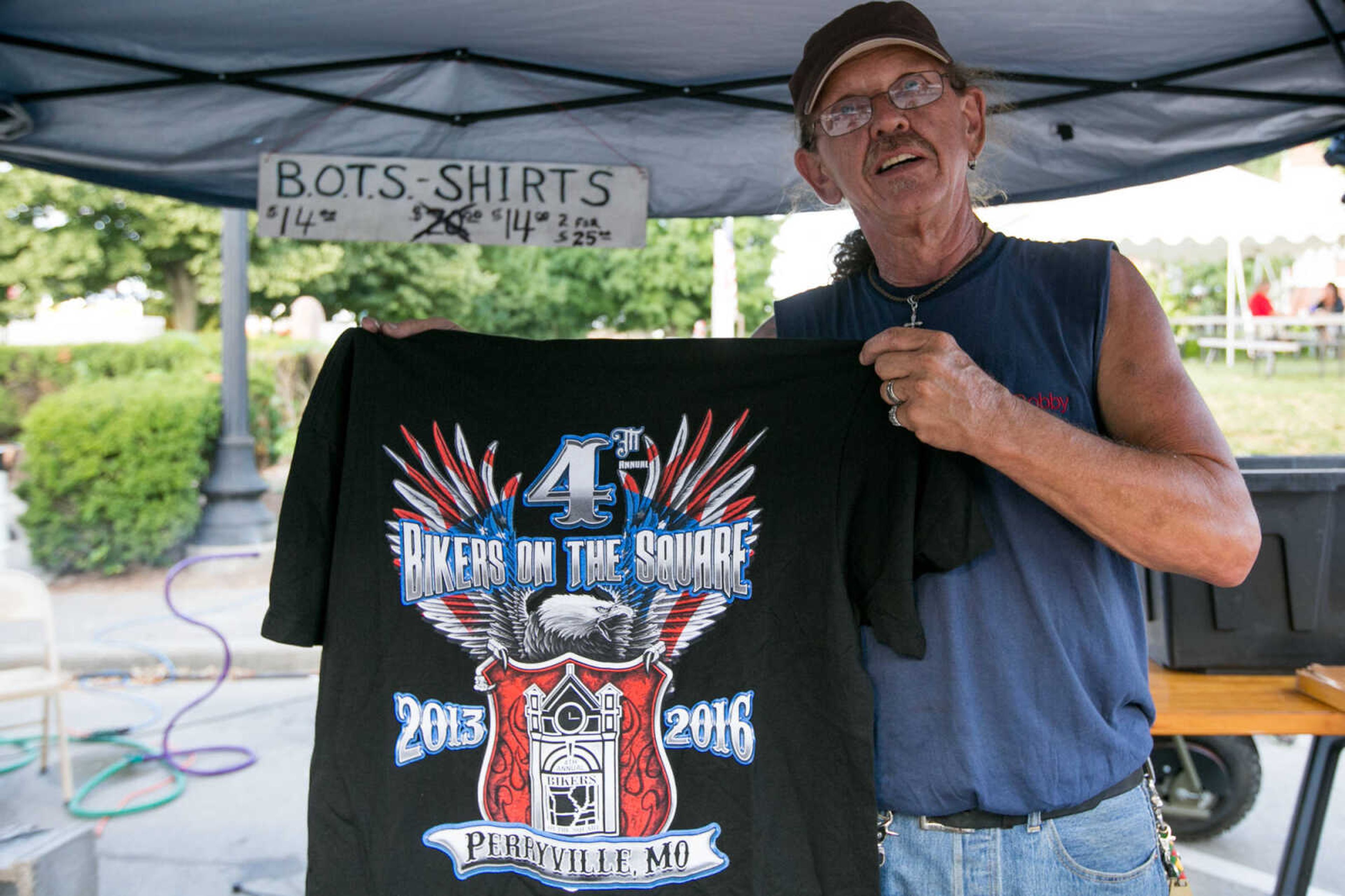 GLENN LANDBERG ~ glandberg@semissourian.com

Bobby Bucy holds up a shirt at his vendor booth during the 4th Annual Bikers on the Square Friday, June 17, 2016 in Perryville, Missouri.