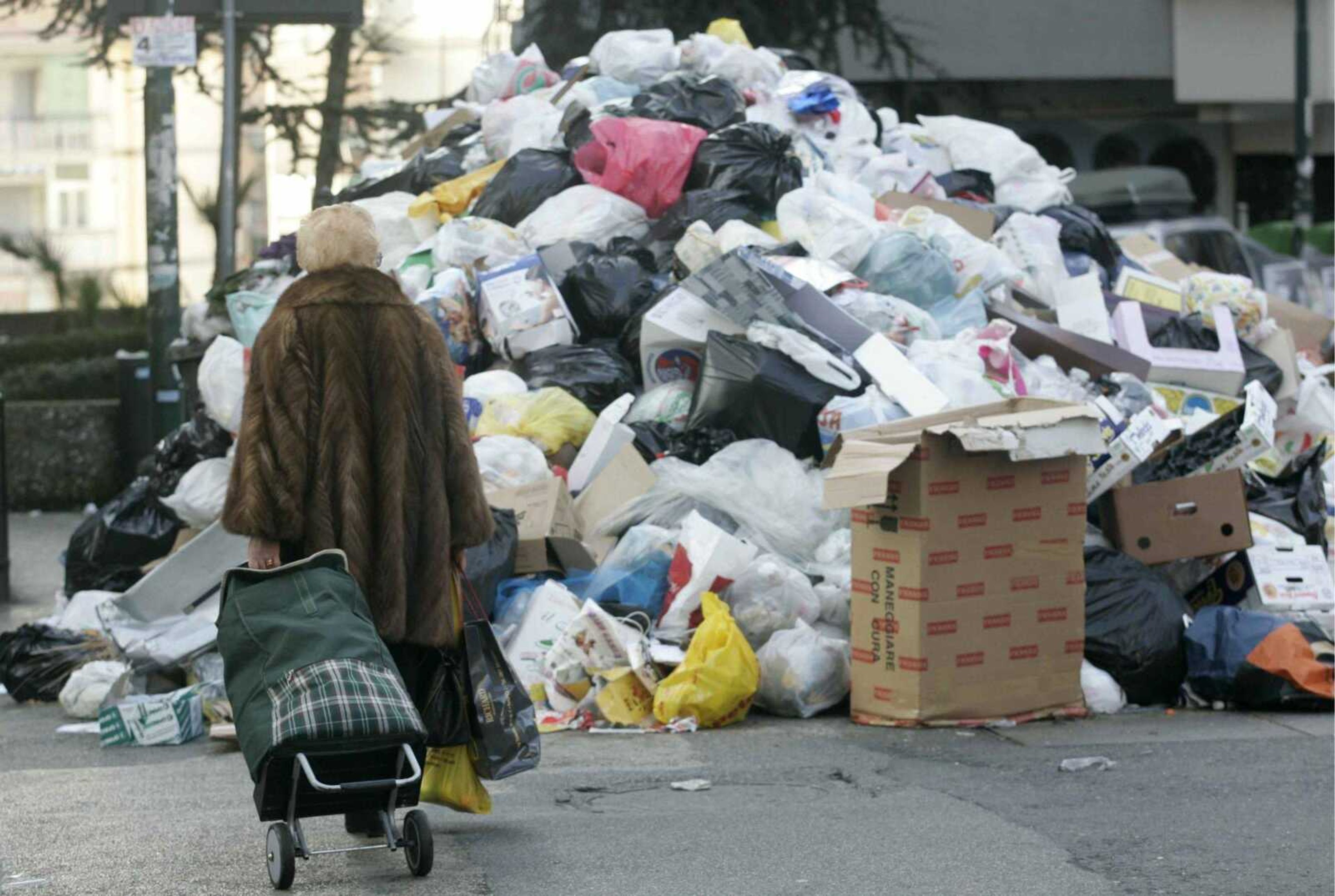 A woman pulled her shopping trolley past a garbage heap Tuesday in downtown Naples, Italy. Premier Romano Prodi announced emergency measures Tuesday to deal with Naples' garbage crisis, including three new incinerators and that other Italian regions might be able to help dispose of the trash. (Salvatore Laporta ~ Associated Press)