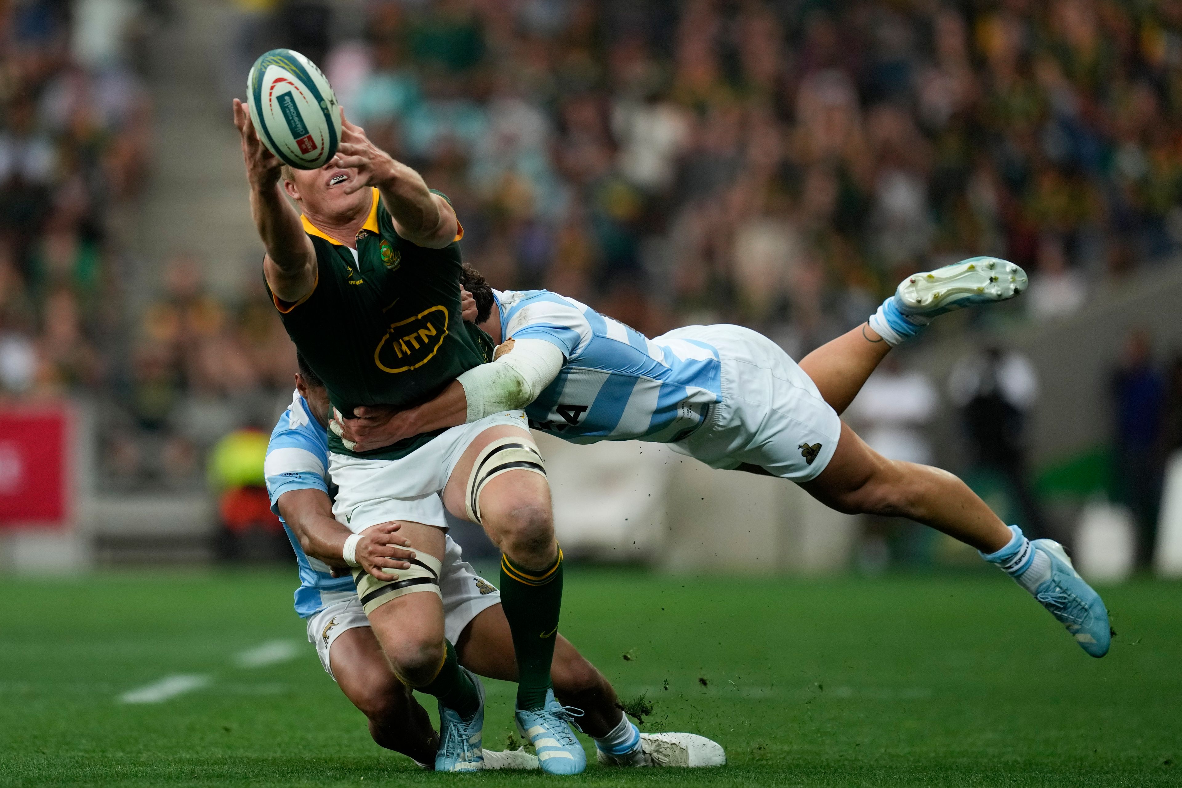 South Africa's Pieter-Steph du Toit, left, is tackled by Argentina's Rodrigo Isgro during a rugby championship test match at Mbombela stadium in Nelspruit, South Africa, Saturday, Sept. 28, 2024. (AP Photo/Themba Hadebe)