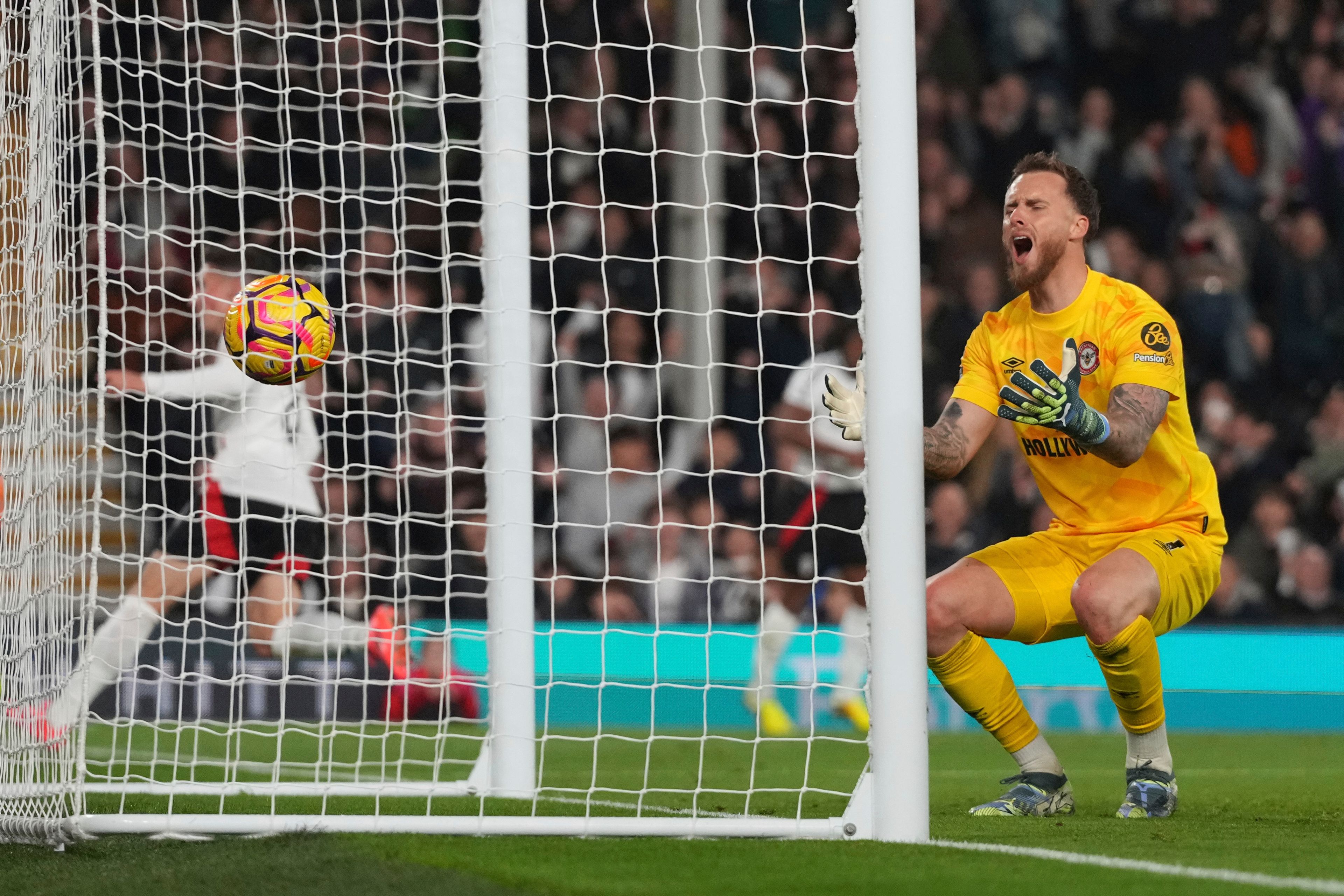 Brentford's goalkeeper Mark Flekken reacts after conceding a goal scored by Fulham's Harry Wilson, his sides first goal, during the English Premier League soccer match between Fulham and Brentford at Craven Cottage stadium in London, Monday, Nov. 4, 2024. (AP Photo/Frank Augstein)