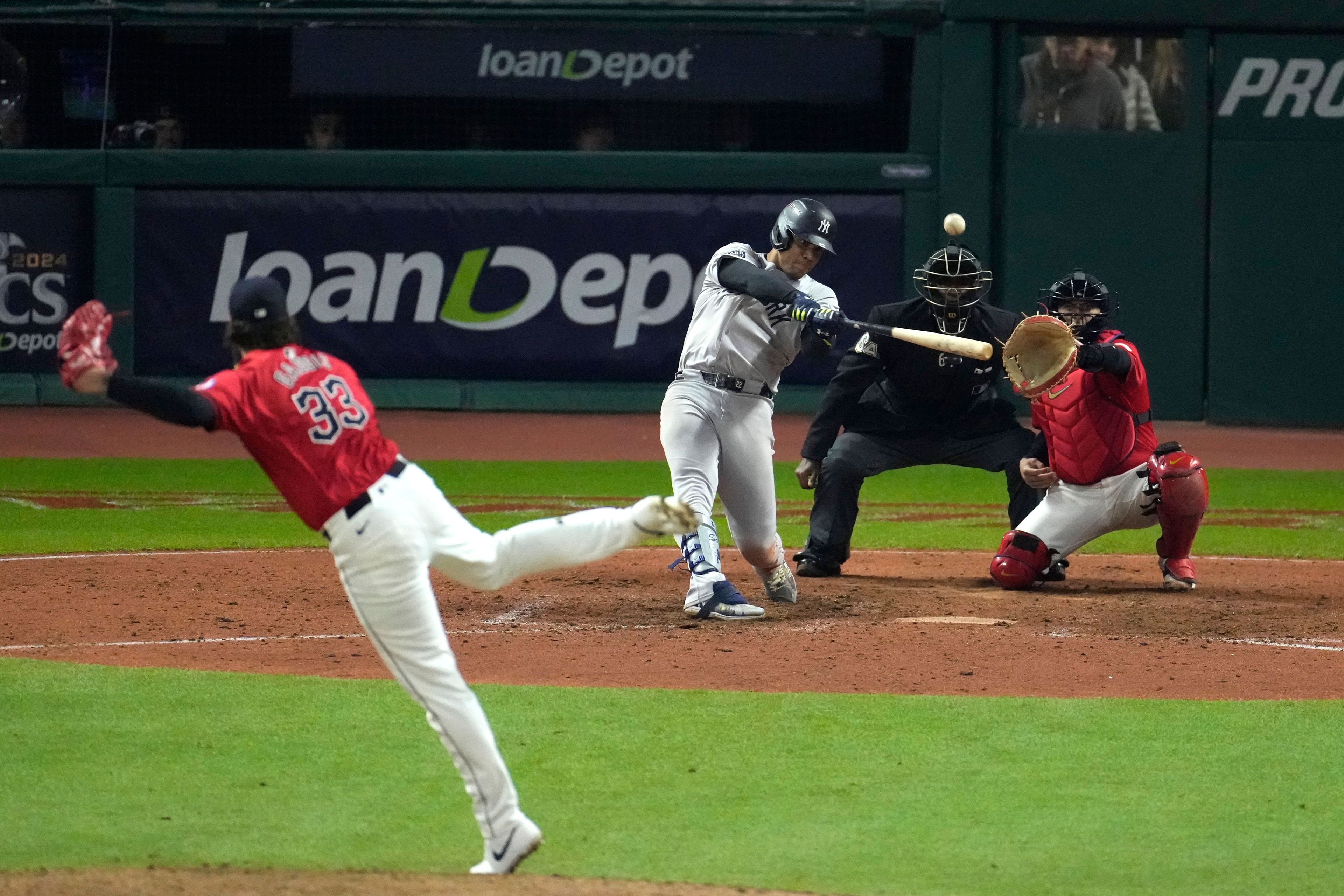 New York Yankees' Juan Soto hits a three-run home run off Cleveland Guardians pitcher Hunter Gaddis (33) during the 10th inning in Game 5 of the baseball AL Championship Series Saturday, Oct. 19, 2024, in Cleveland. (AP Photo/Jeff Roberson)