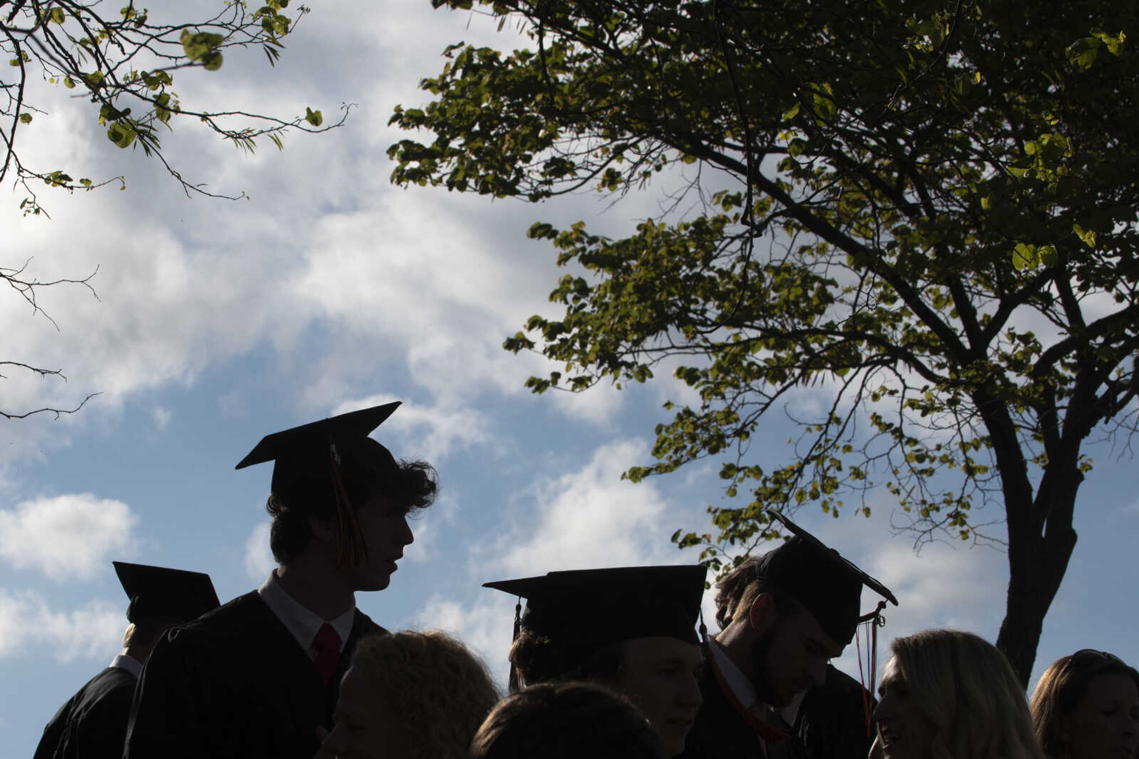 Cape Central graduate Eric Gillot, a foreign exchange student from Milan, Italy, is silhouetted against the sky near other graduates after Cape Central High School's Class of 2019 Commencement on Sunday, May 12, 2019, at the Show Me Center in Cape Girardeau.