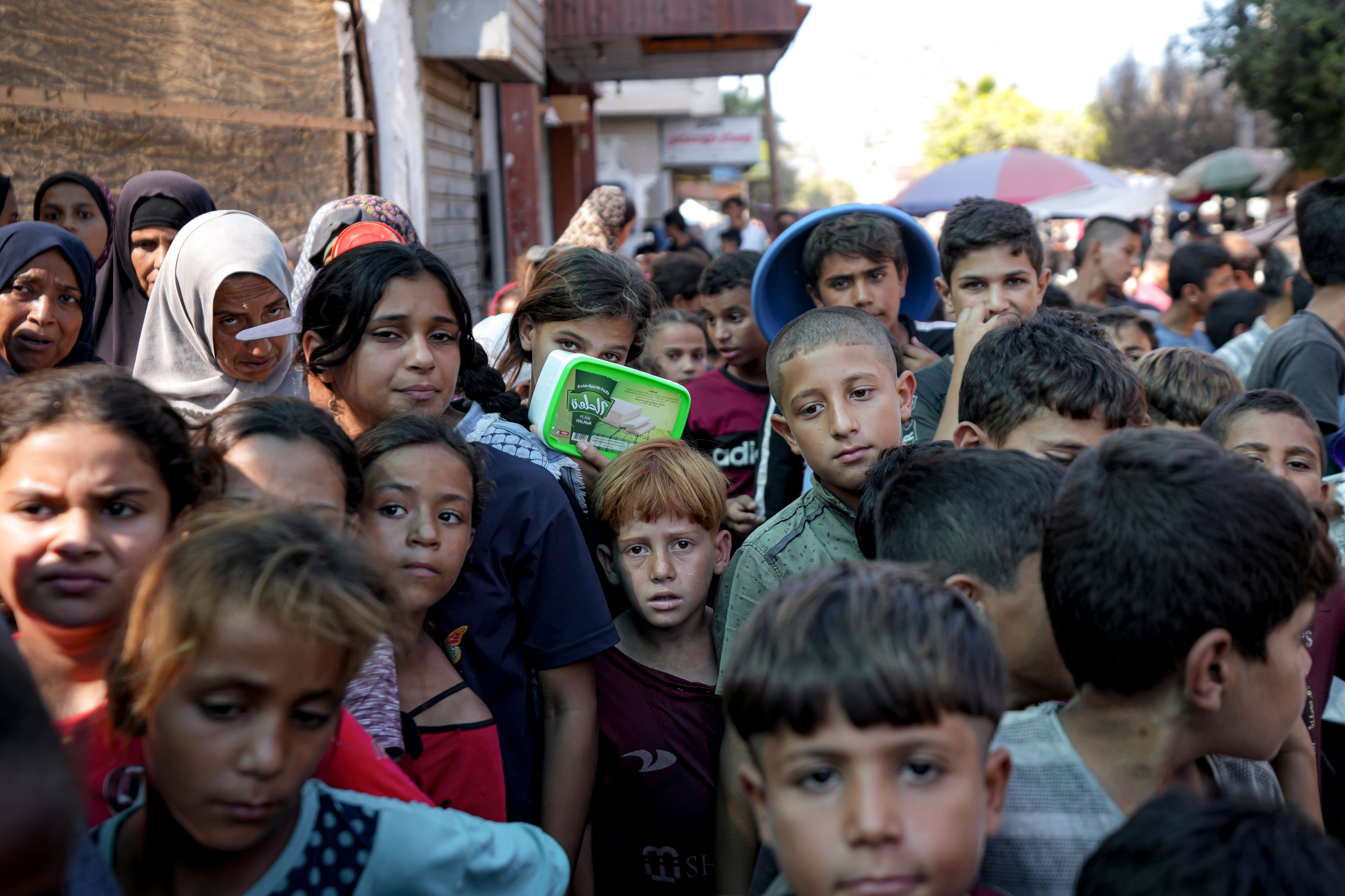 Palestinians line up for food distribution in Deir al-Balah, Gaza Strip, Thursday, Oct. 17, 2024. (AP Photo/Abdel Kareem Hana)