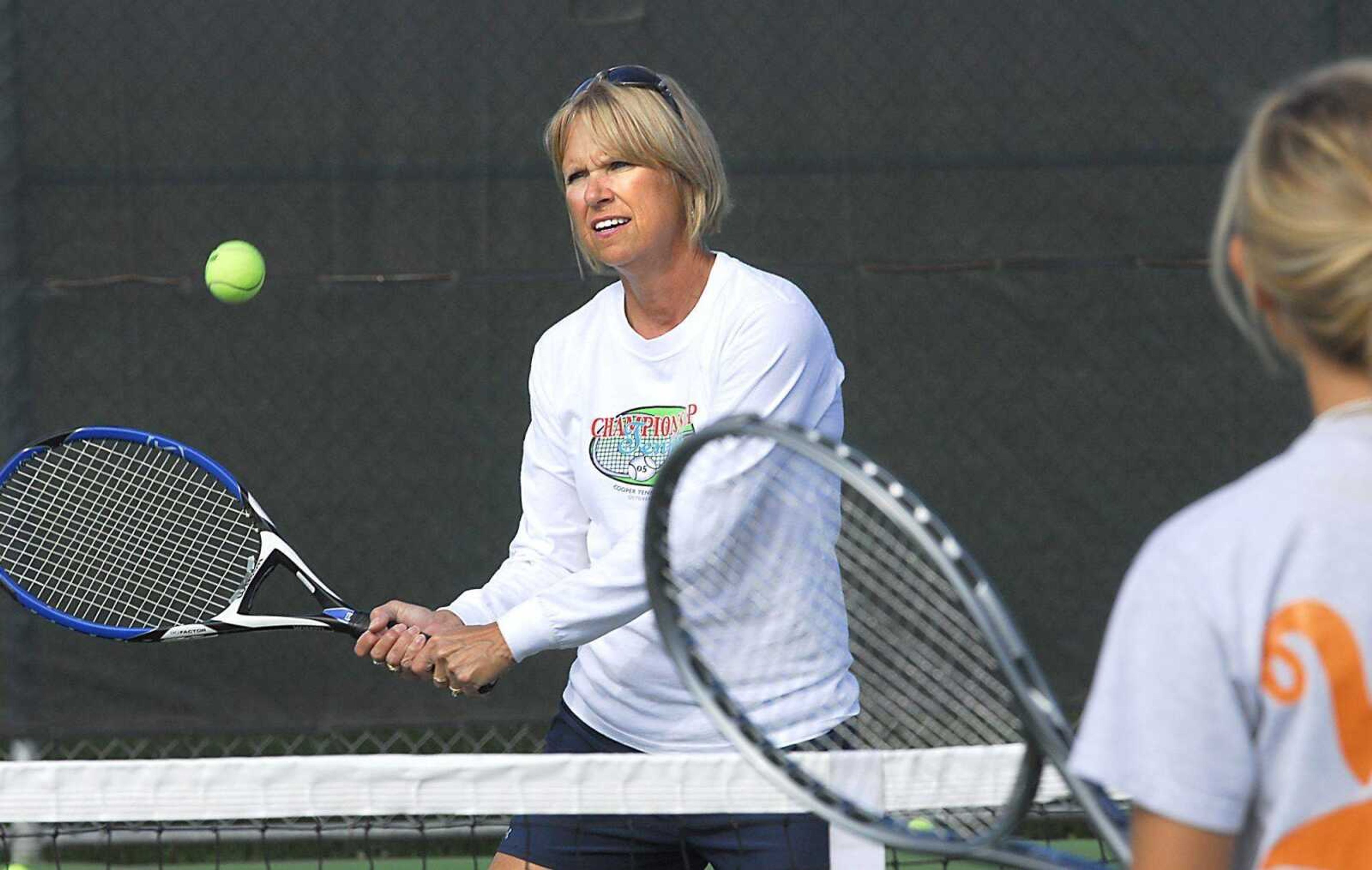 Central tennis coach Annette Slattery practiced with Sarah Ford on Tuesday. Slattery will coach her last event this week at the state tournament. (Fred Lynch)