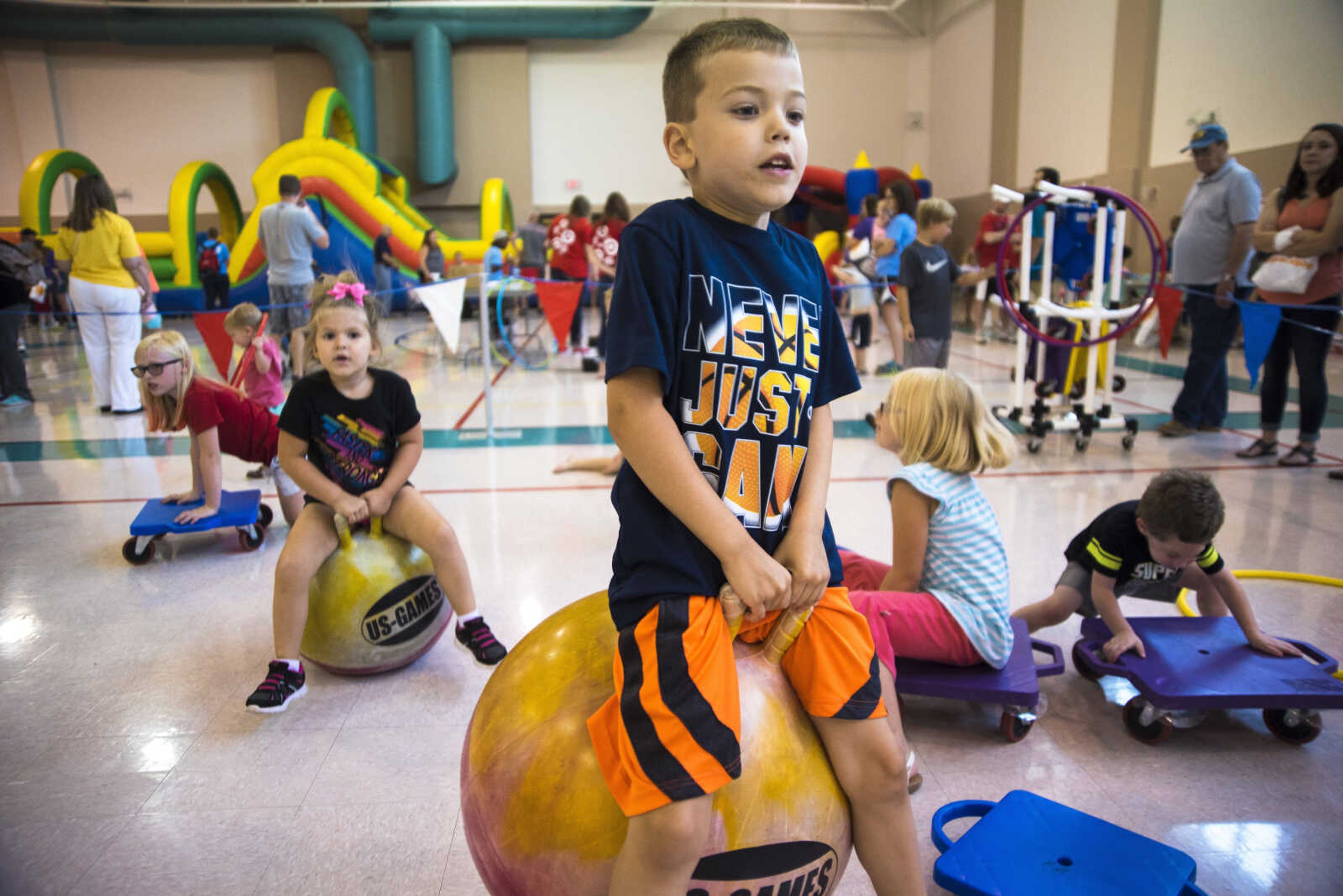 Kids bounce around during the Parks and Rec Day Friday, July 7, 2017 at the Osage Centre in Cape Girardeau.